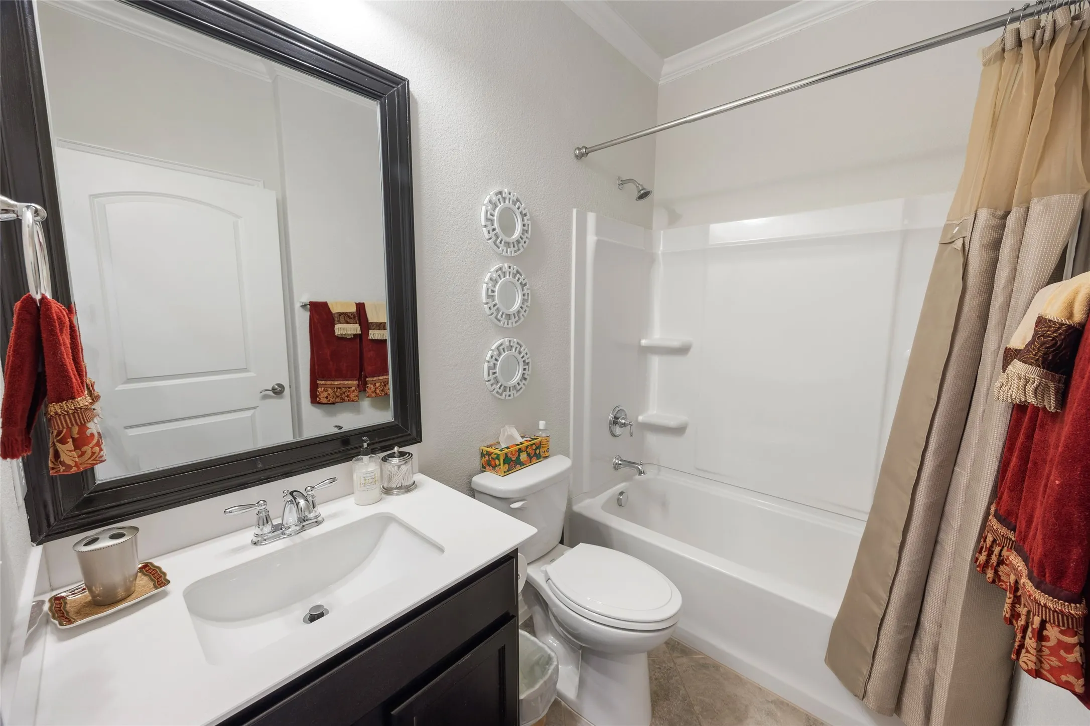 Vanity with a single basin, chrome fixtures, and a framed mirror