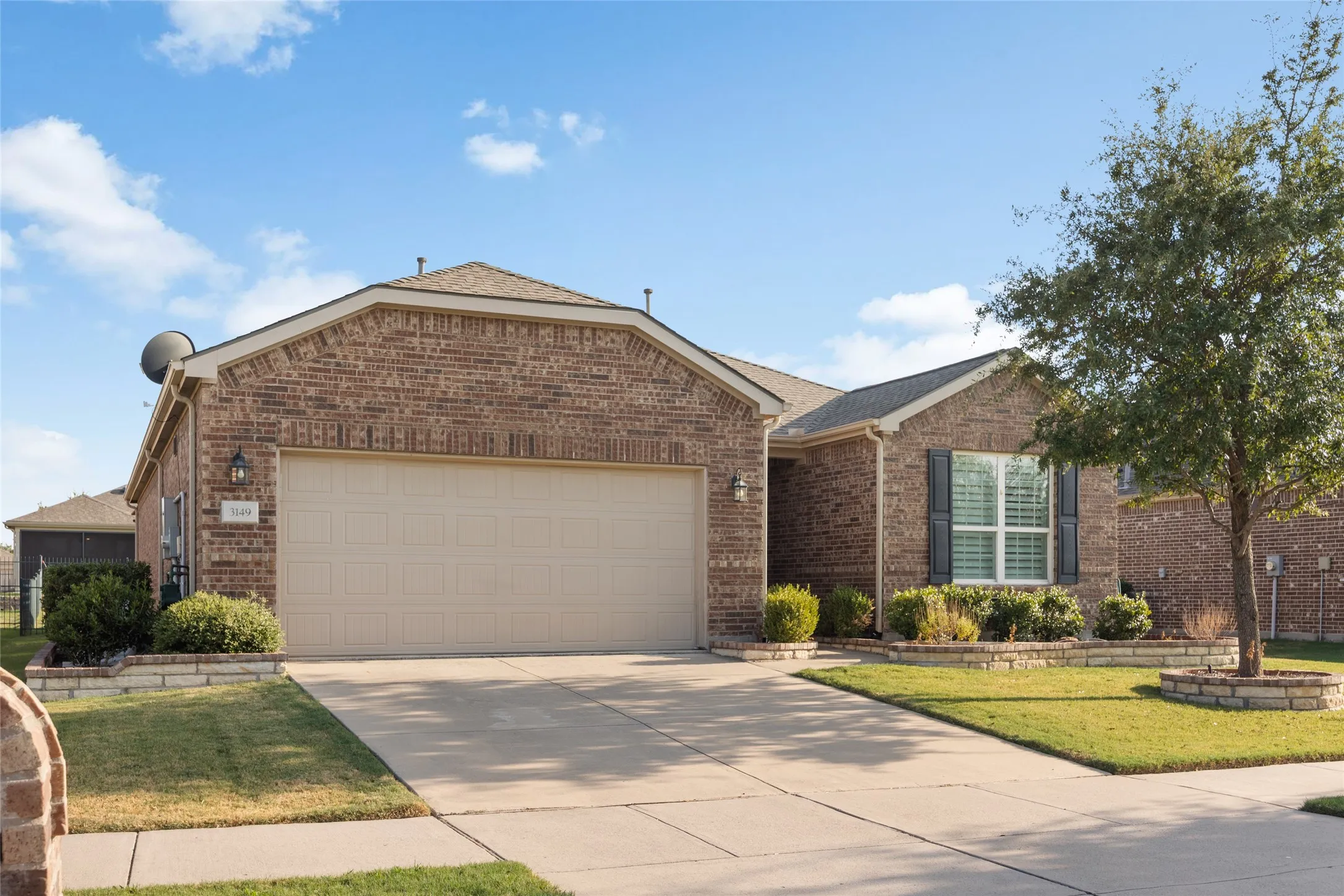 Brick exterior facade with an attached two-car garage