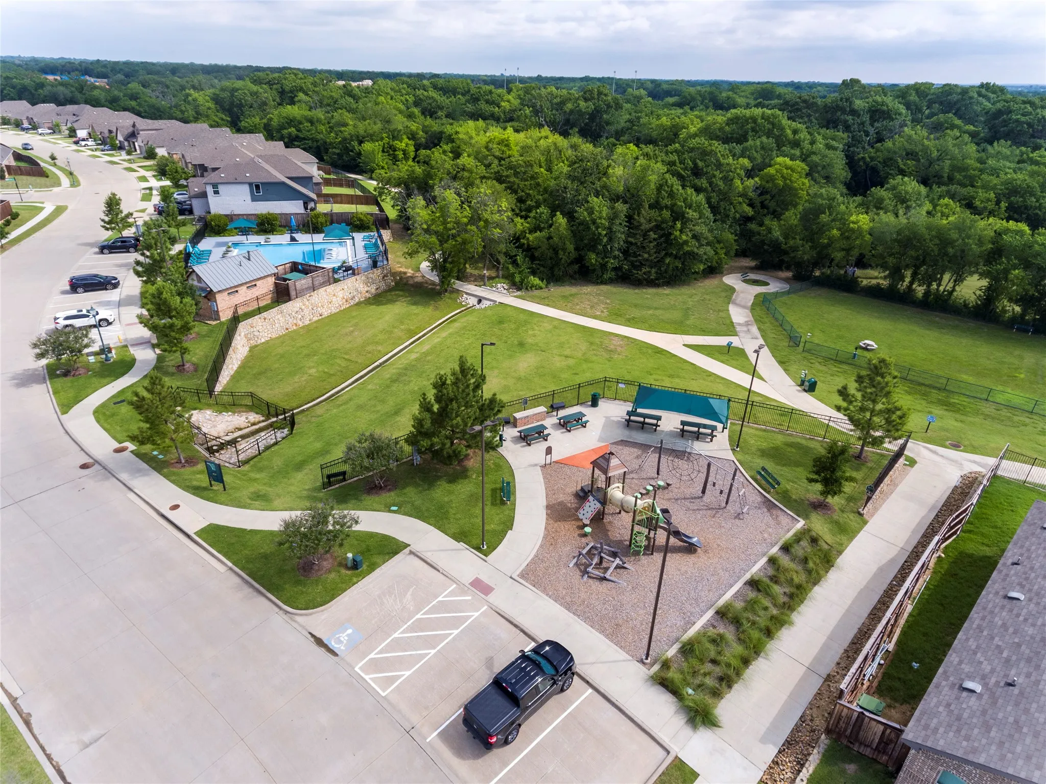 Community amenities featuring a swimming pool, playground, covered picnic areas, walking paths, and green spaces