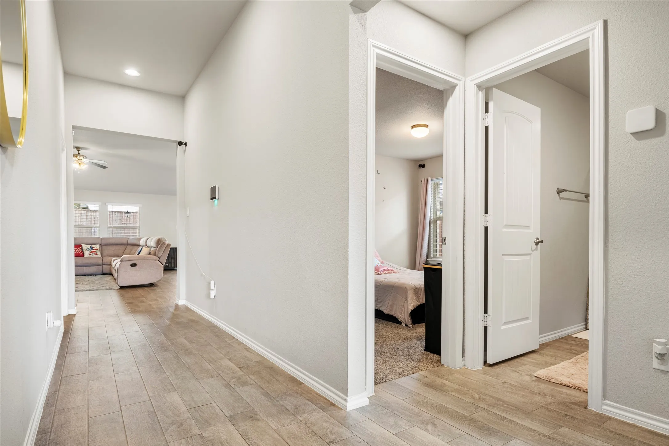 View from the entry....down the hall to the living area and the two additional bedrooms on the right separated by the bathroom.....
