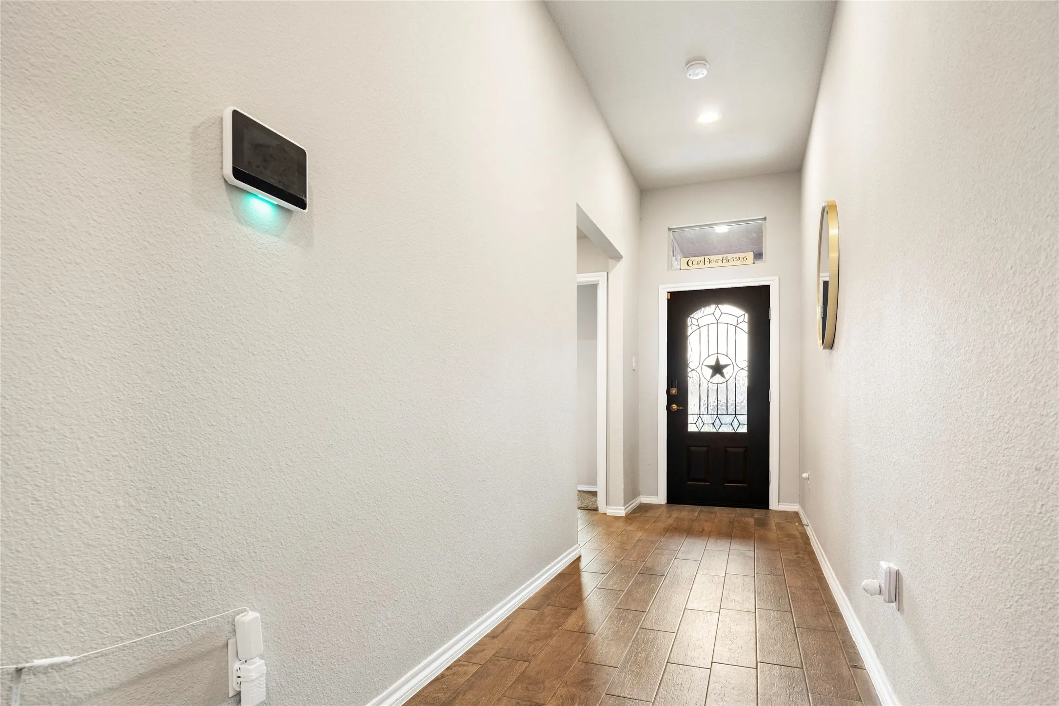 Lovely dark-paneled front door featuring decorative glass insert....