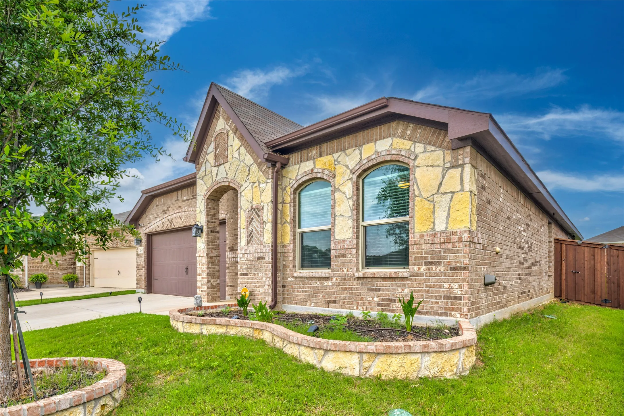 Brick and stone façade with arched entry and arched windows.....