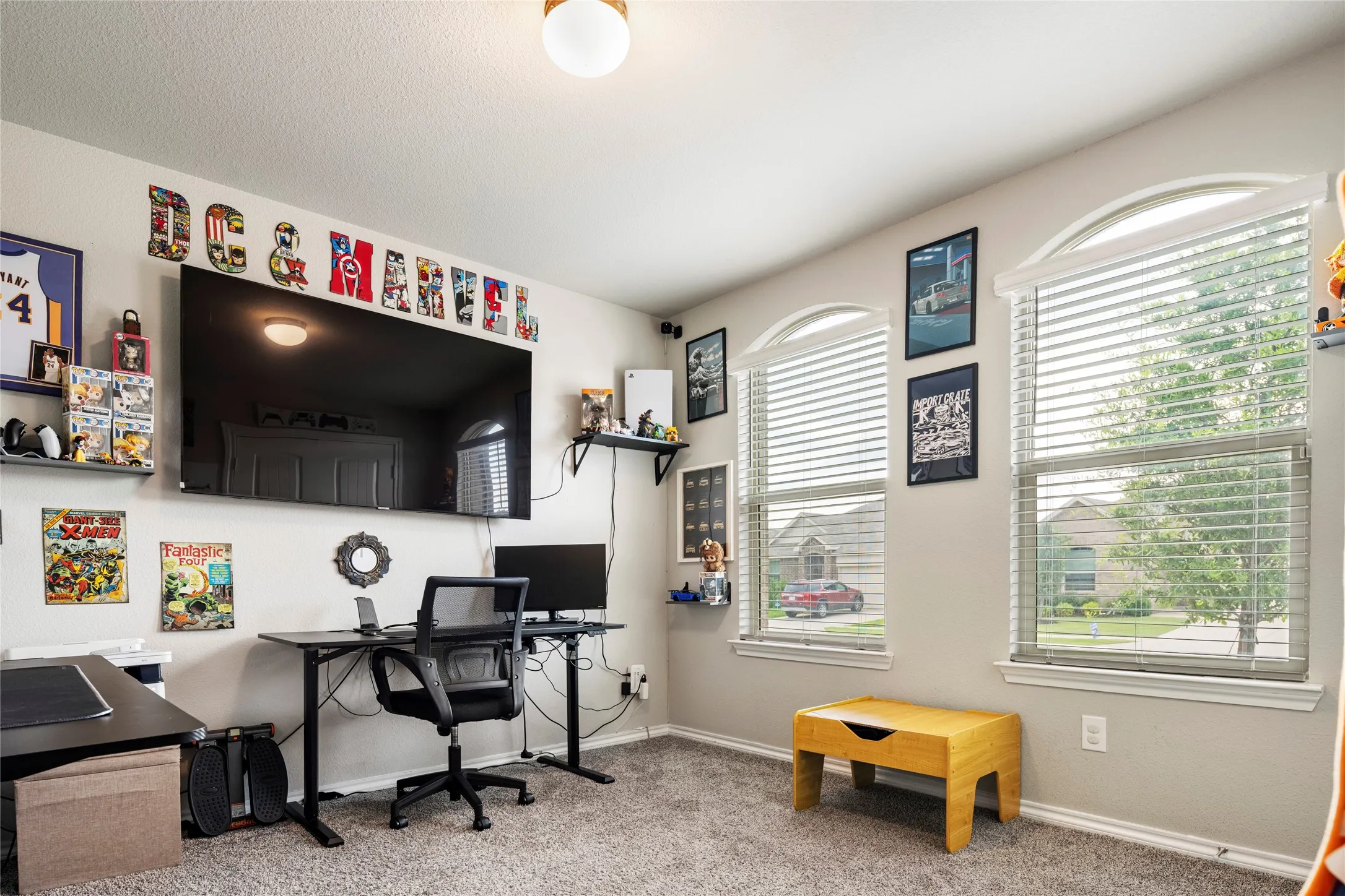 3rd bedroom with two arched windows with blinds, and a flush mount ceiling light....