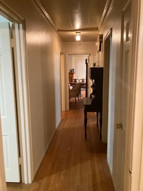 Hardwood flooring throughout, beadboard ceiling, recessed lighting, and panel doors