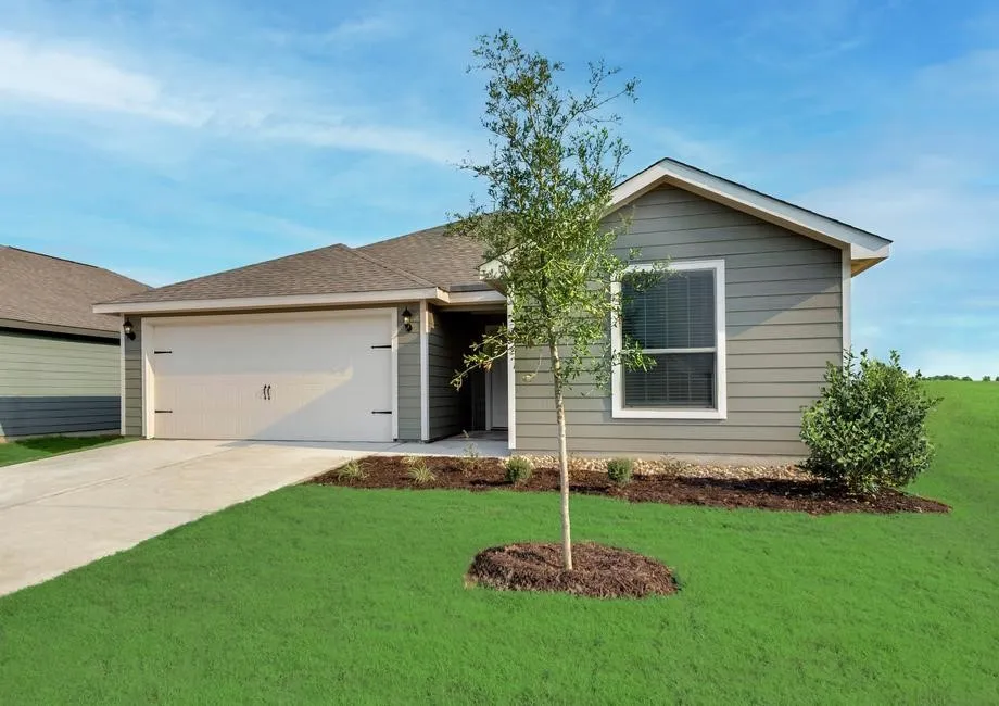 Gray horizontal siding, attached two-car garage, concrete driveway, front yard landscaping, and a pitched roof