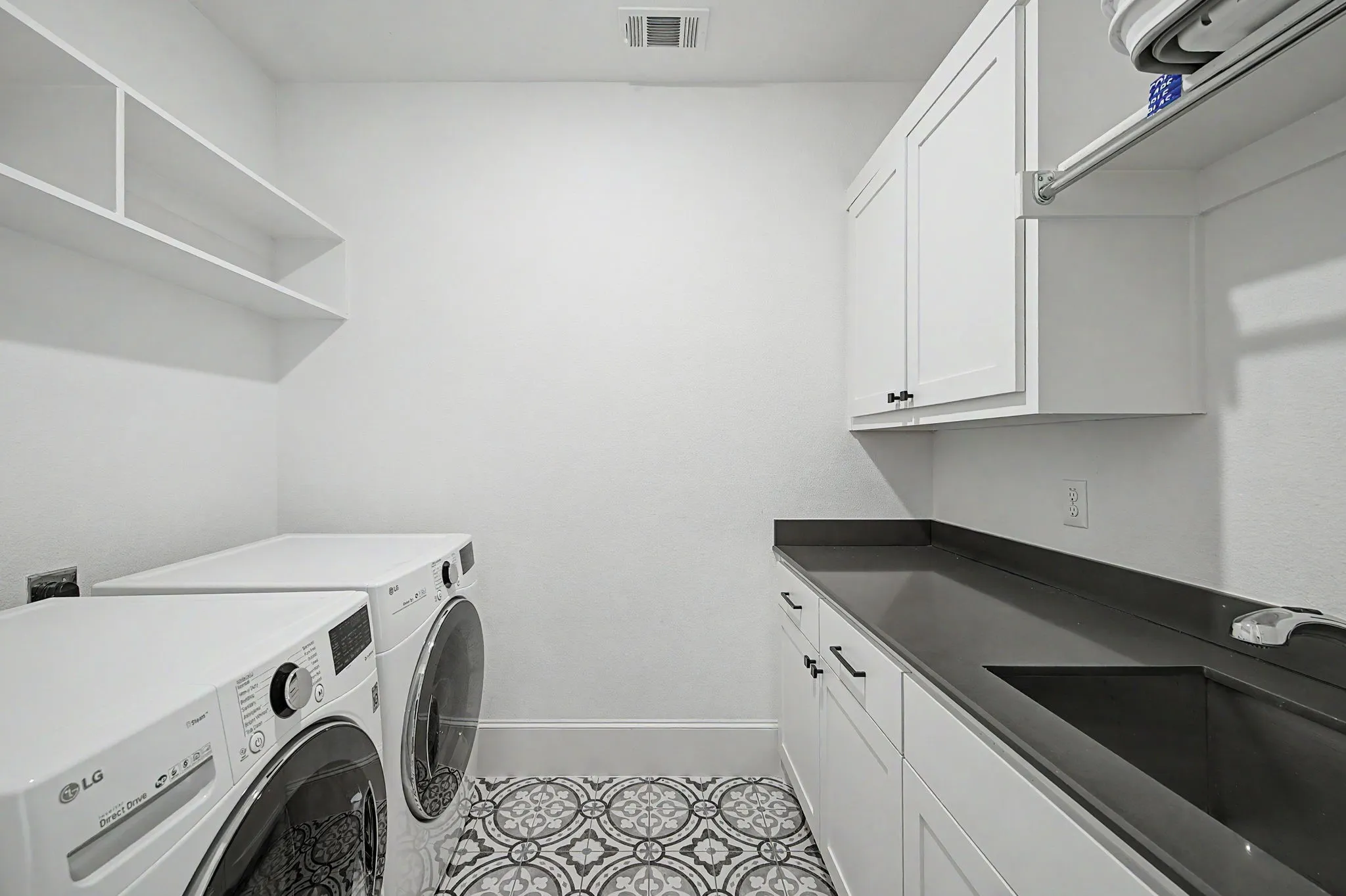 Upstairs laundry room with sink