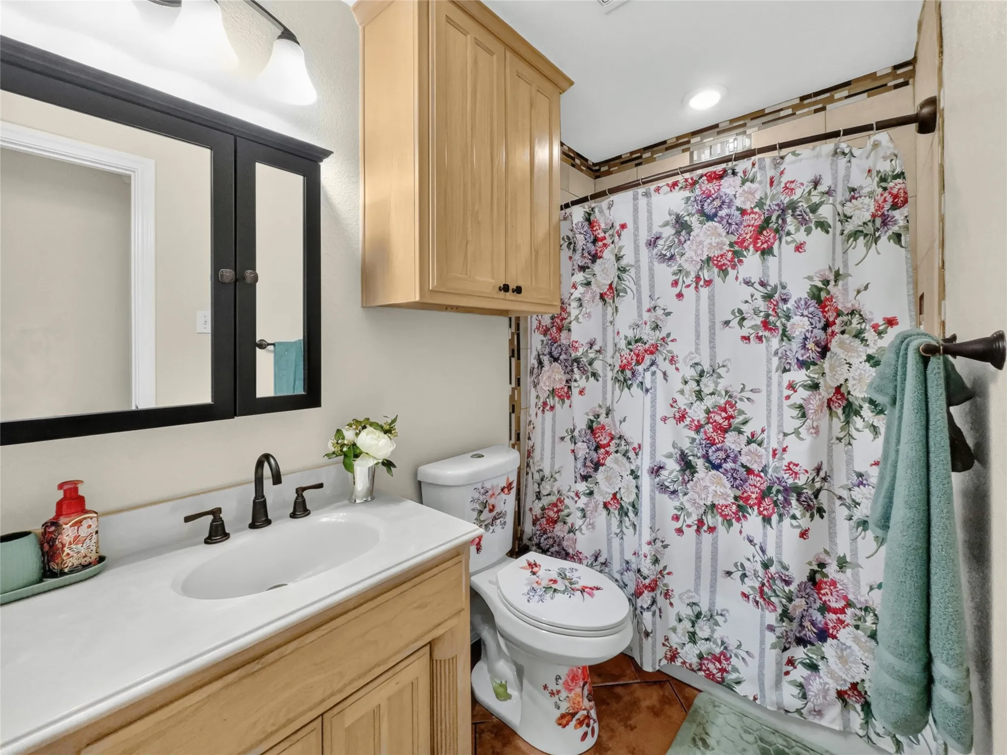 Vanity with white countertop, undermount sink, and dark bronze faucet