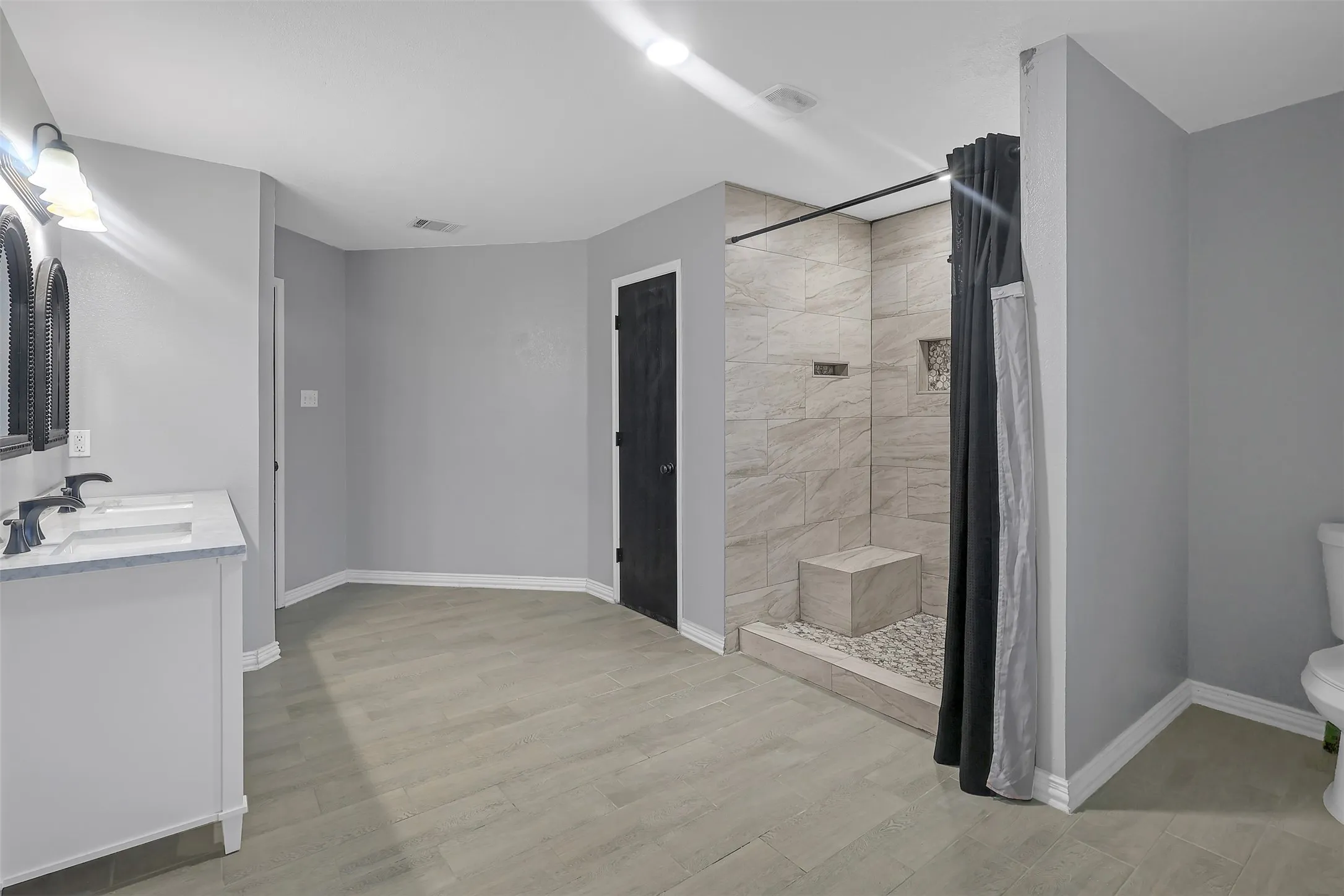 Bathroom featuring a stall shower and light wood-style flooring