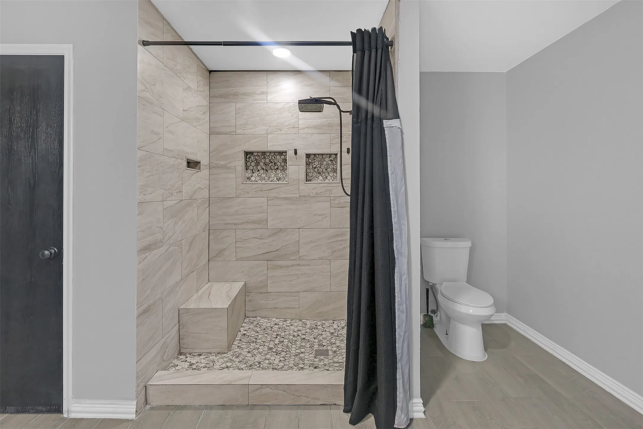 Full bathroom with a stall shower and wood finished floors