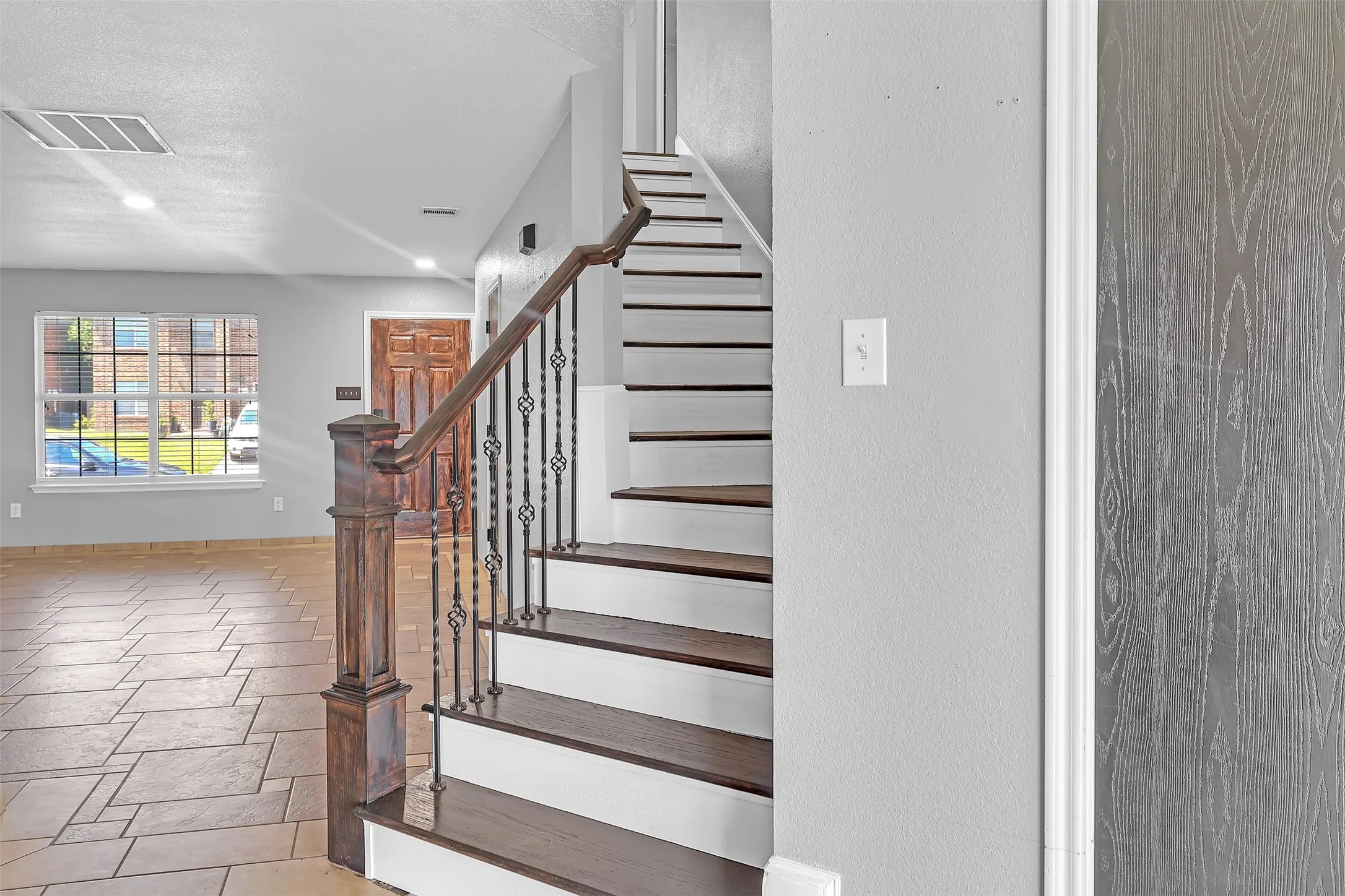 Staircase with recessed lighting and baseboards