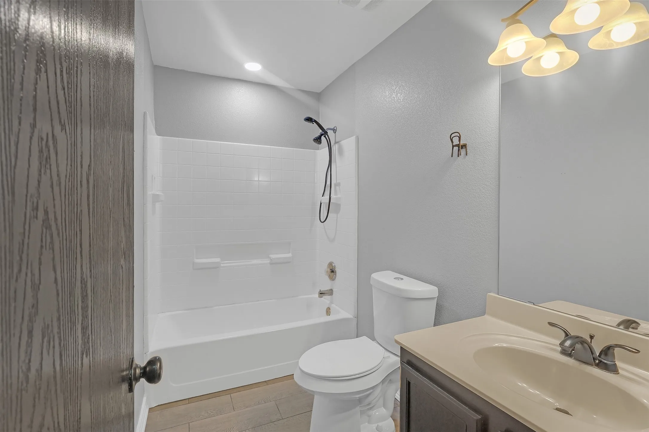 Bathroom featuring vanity,  shower combination, and light tile patterned flooring