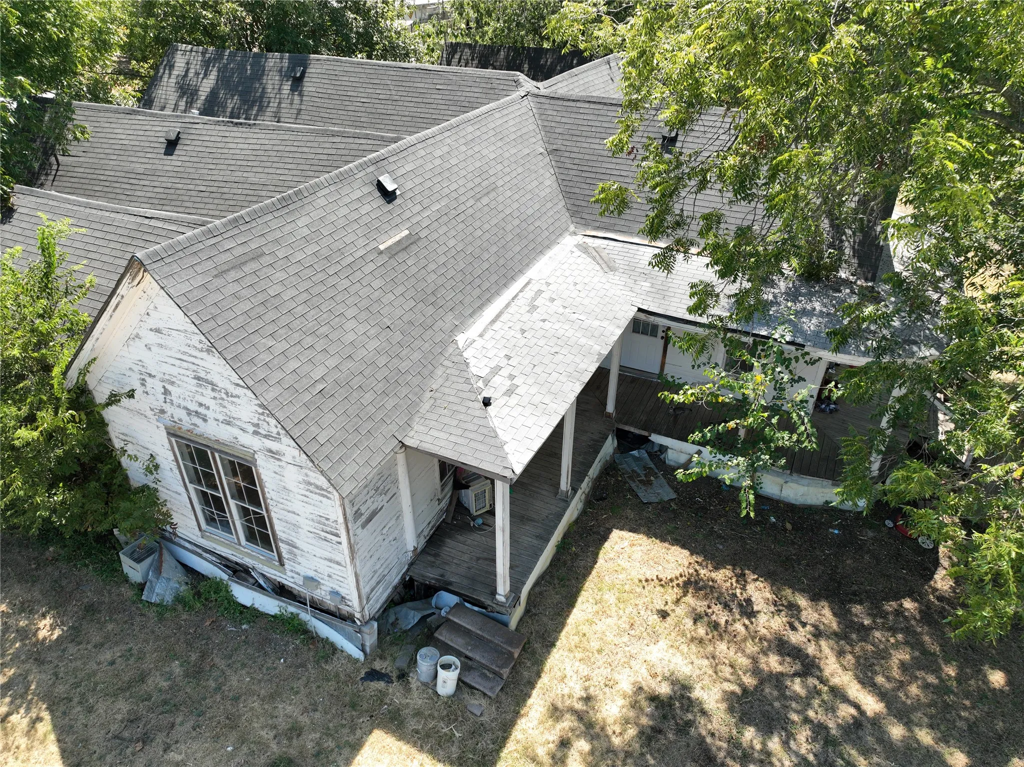 Pitched rooflines, multiple windows, and covered porch