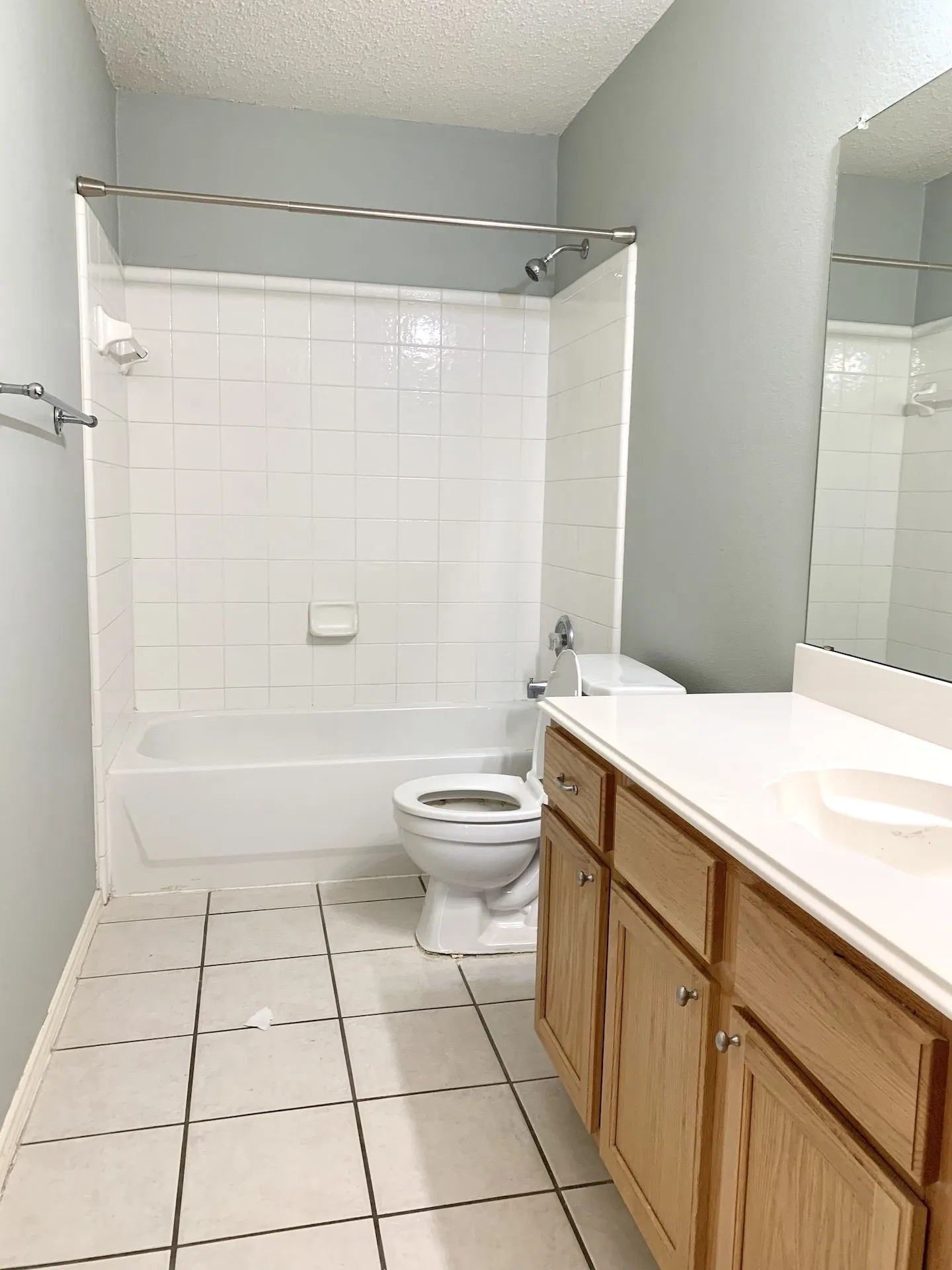 Shower/tub combination with white tile surround