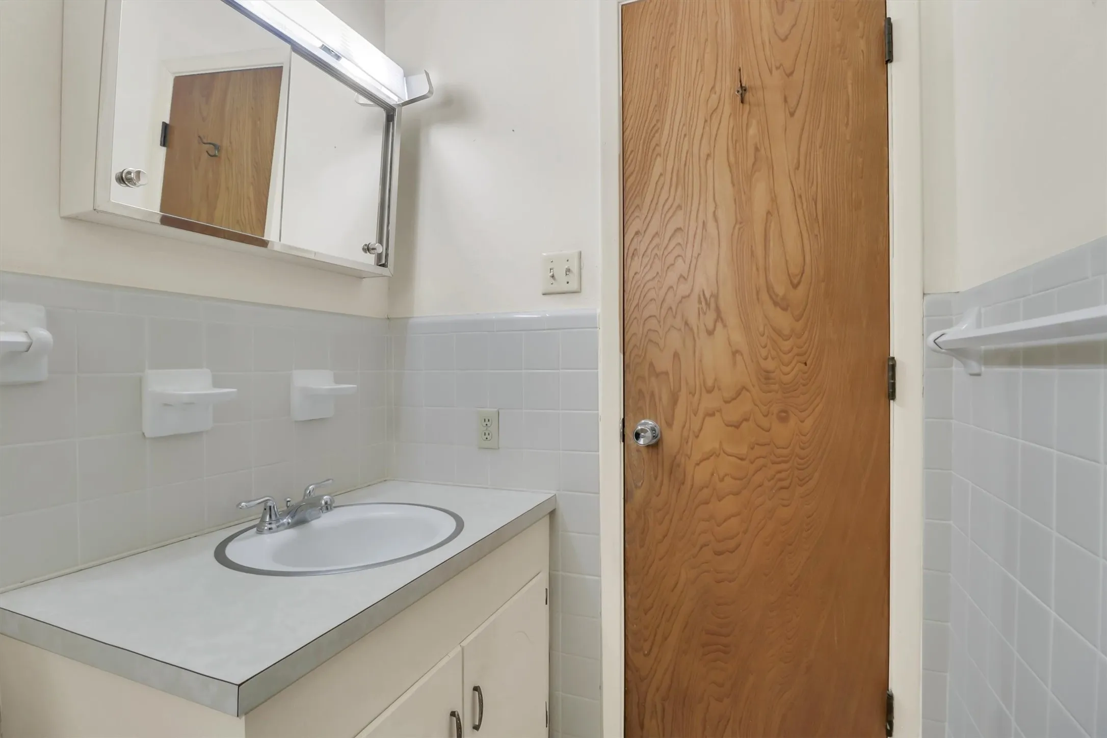Bathroom vanity with an integrated sink and chrome faucet