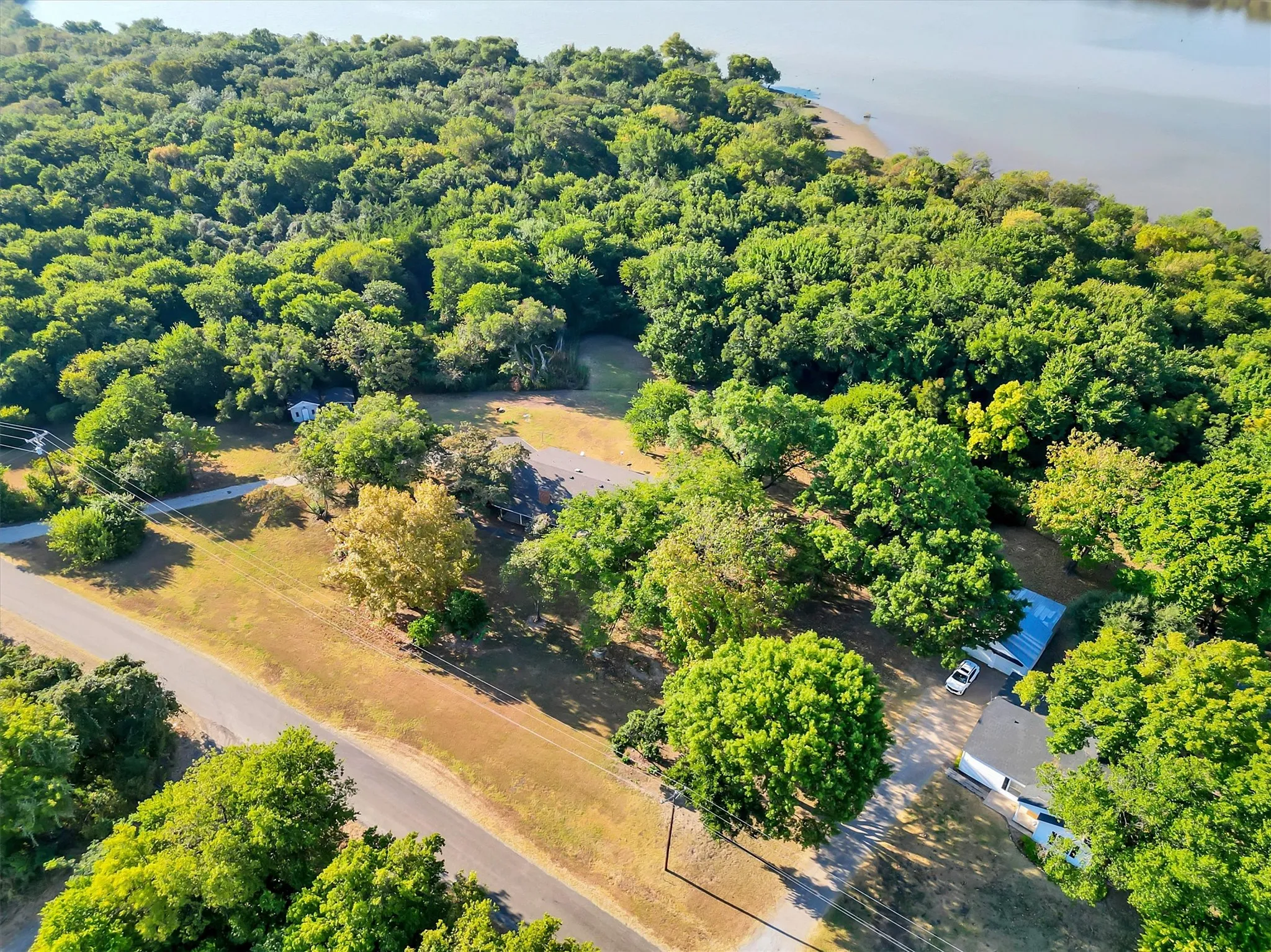 Expansive treed lot bordering a body of water