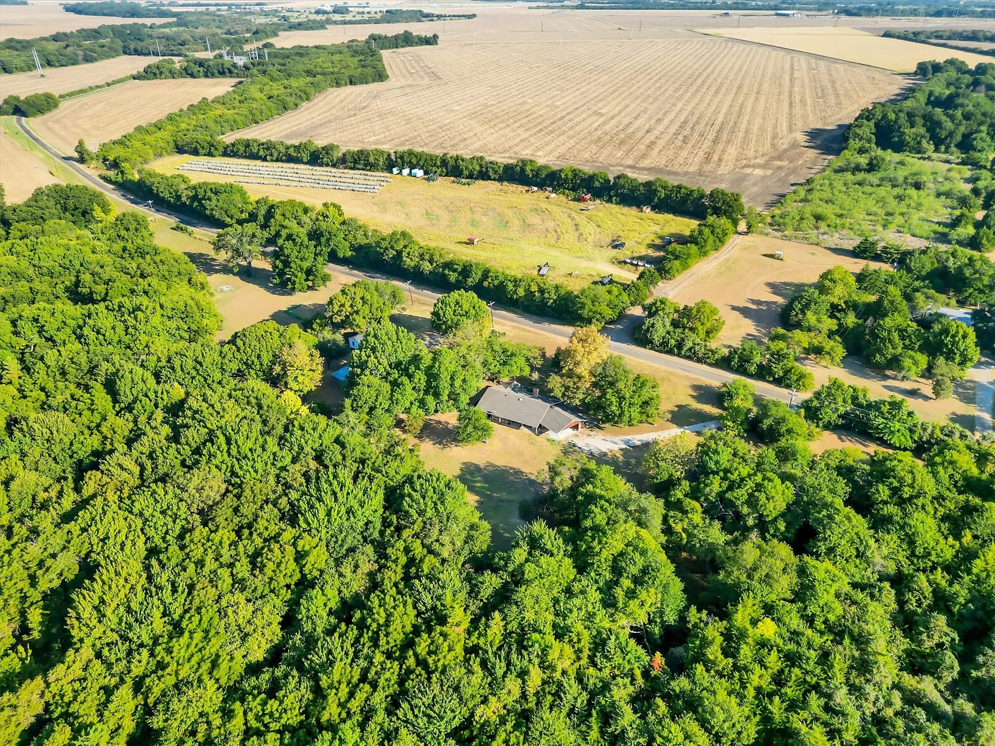 Expansive acreage featuring mature trees and cultivated fields