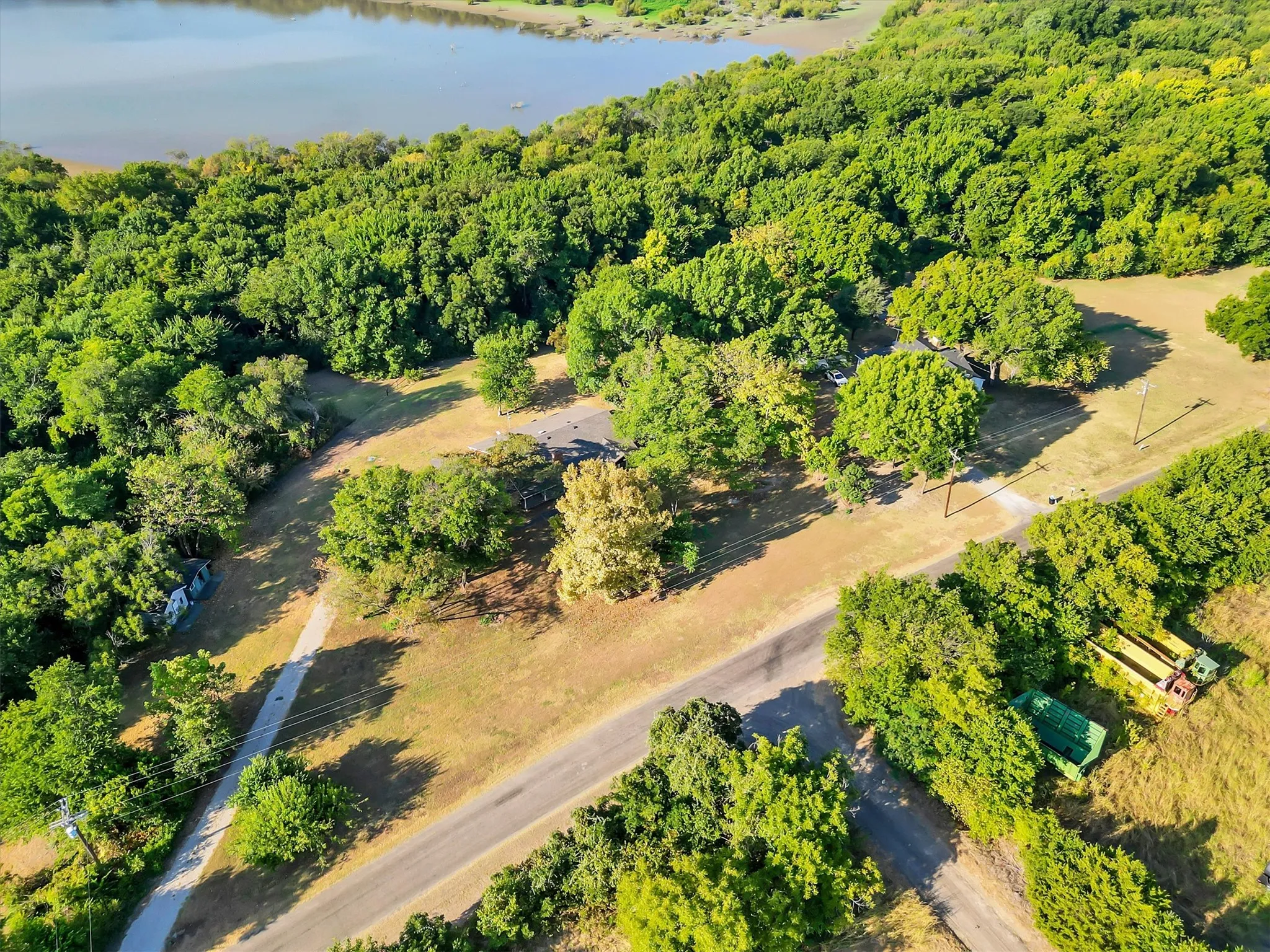 Expansive natural landscape featuring lush trees and a prominent water body