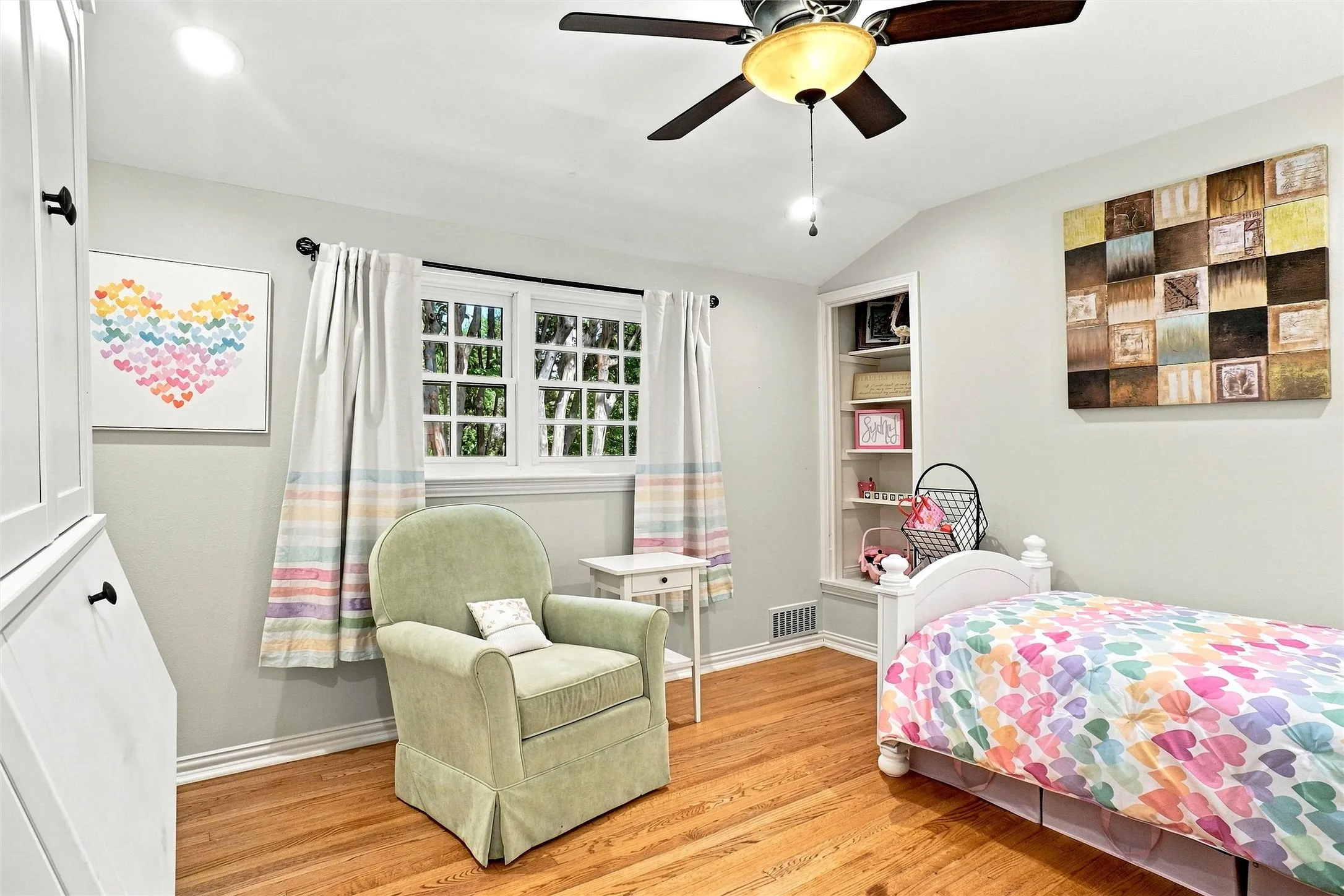 This is one of the 4 secondary rooms with built-in shelves, ceiling fan, and a great walk-in closet.