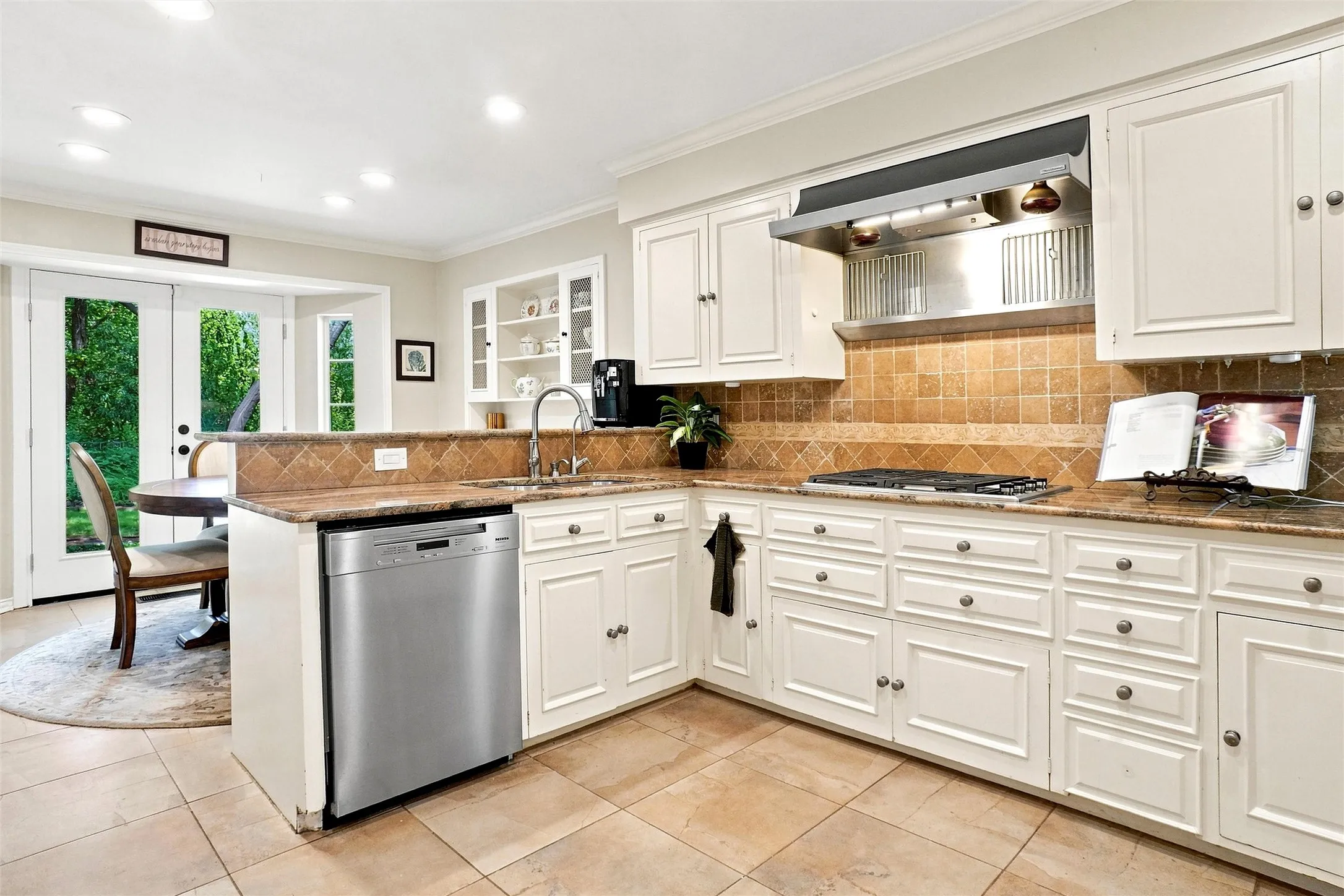 The utility room, breakfast area, kitchen, and half bath off of the kitchen all have this nice oversized-tile floor.