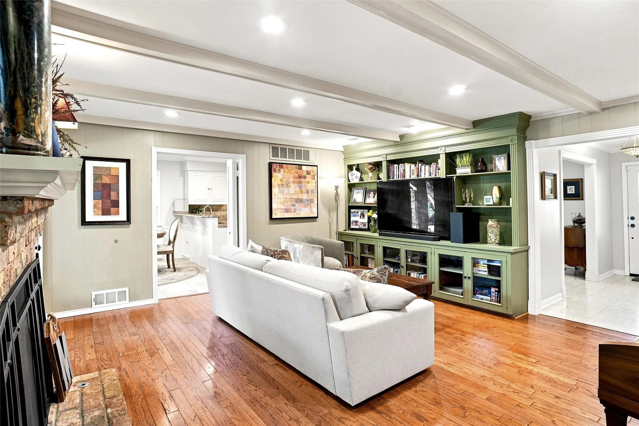 This is another view of the family room which shows the built-in cabinetry and a peek into the breakfast area. Here you find the recessed LED lighting as seen through most of the home.  A very warm and relaxing room.