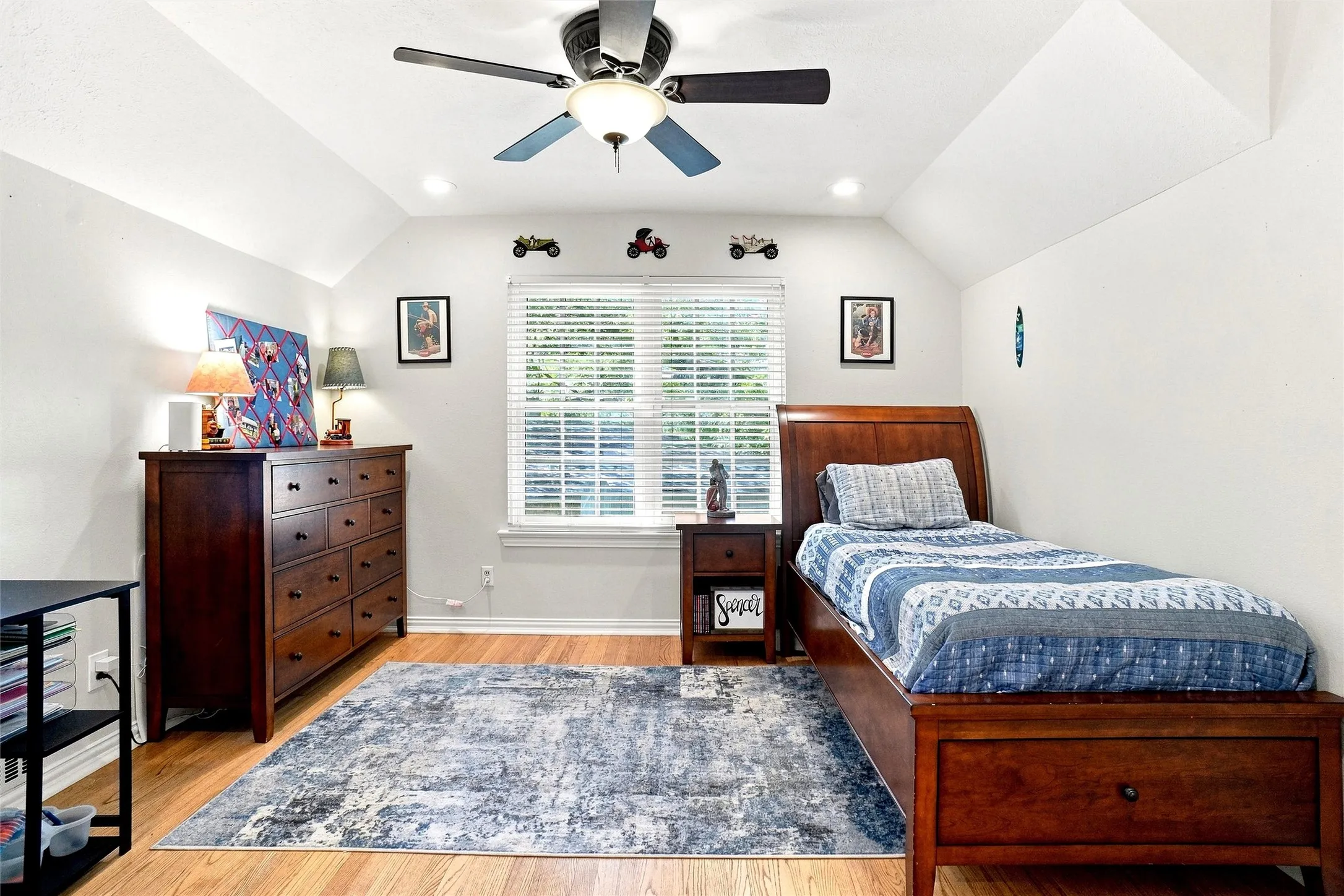Another secondary bedroom upstairs with a special ceiling, ceiling fan, wood flooring, and a nice walk-in closet.
