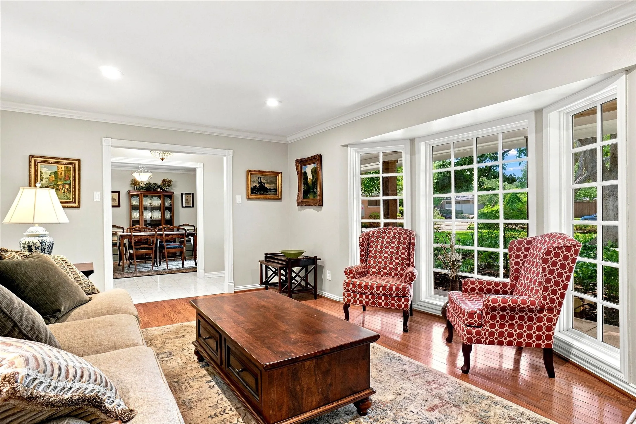 
This  is a beautiful view of the open airy space and the lovely windows overlooking the front porch and gardens. The designer paint colors are fresh and lovey.