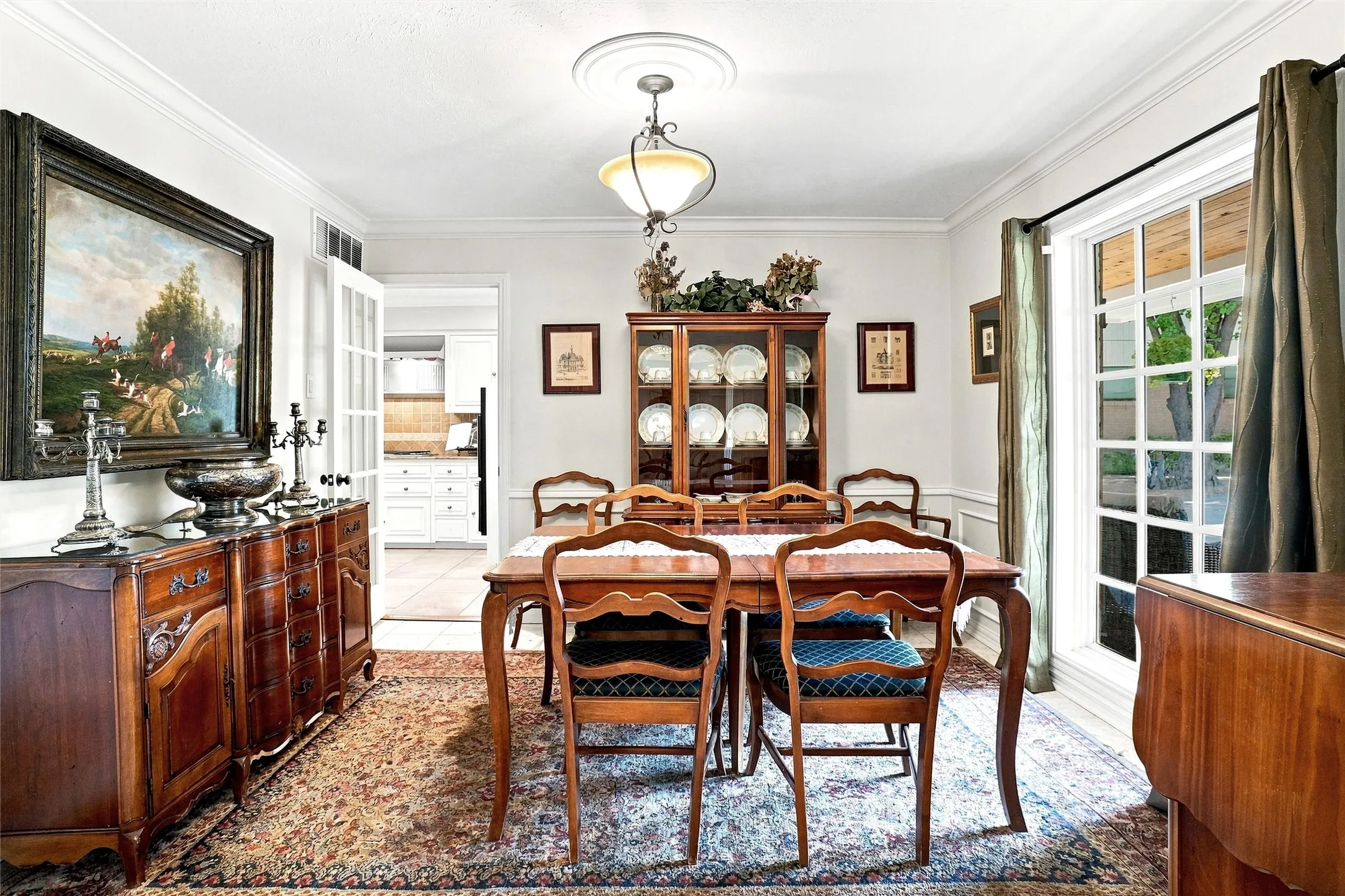 Located to the right of the entry way, this lovingly cared for room offers crown molding, a magnificent window, and the rich, timeless Terrazzo tile that flows effortlessly from the entry.