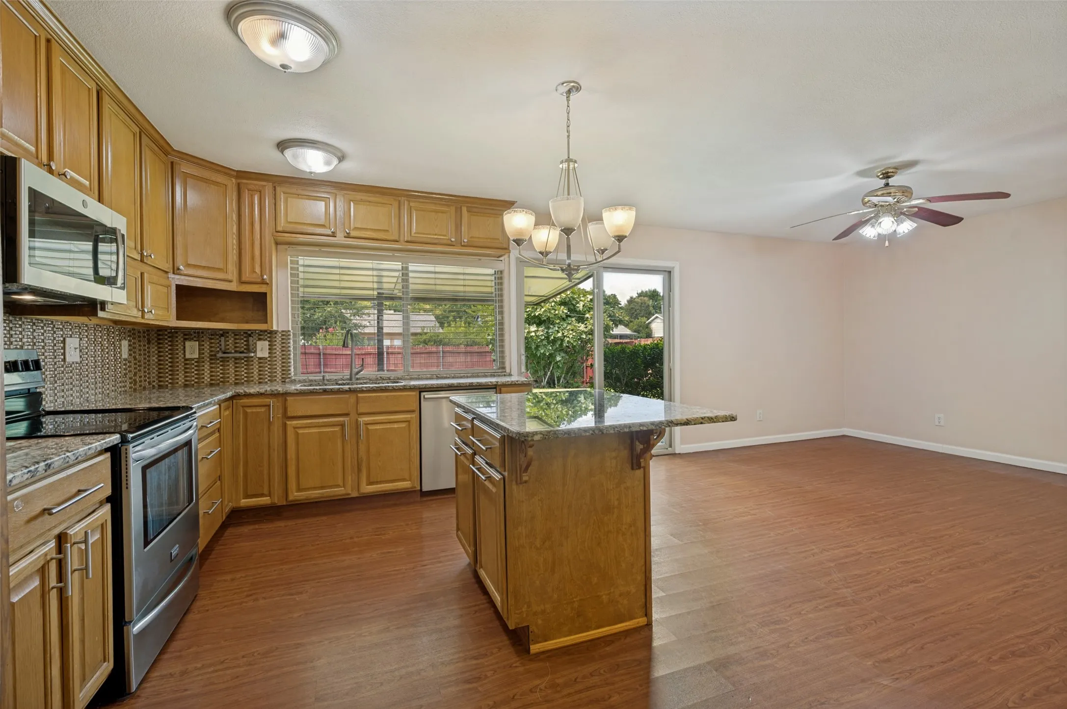 Kitchen featuring wood-finish cabinetry, granite countertops, and stainless steel appliances