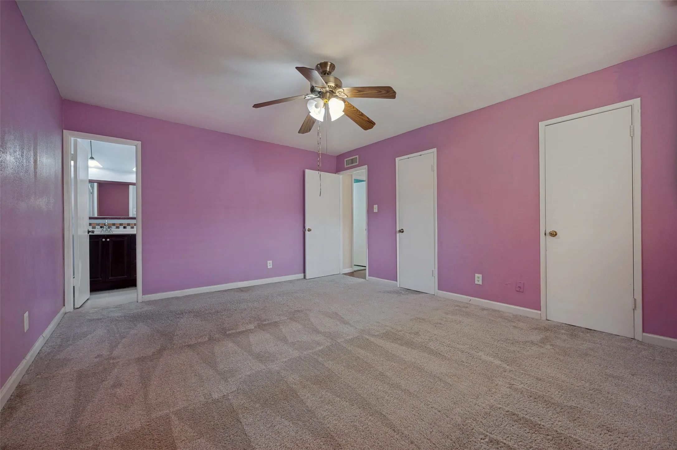 Carpeted flooring, ceiling fan, and multiple interior doors