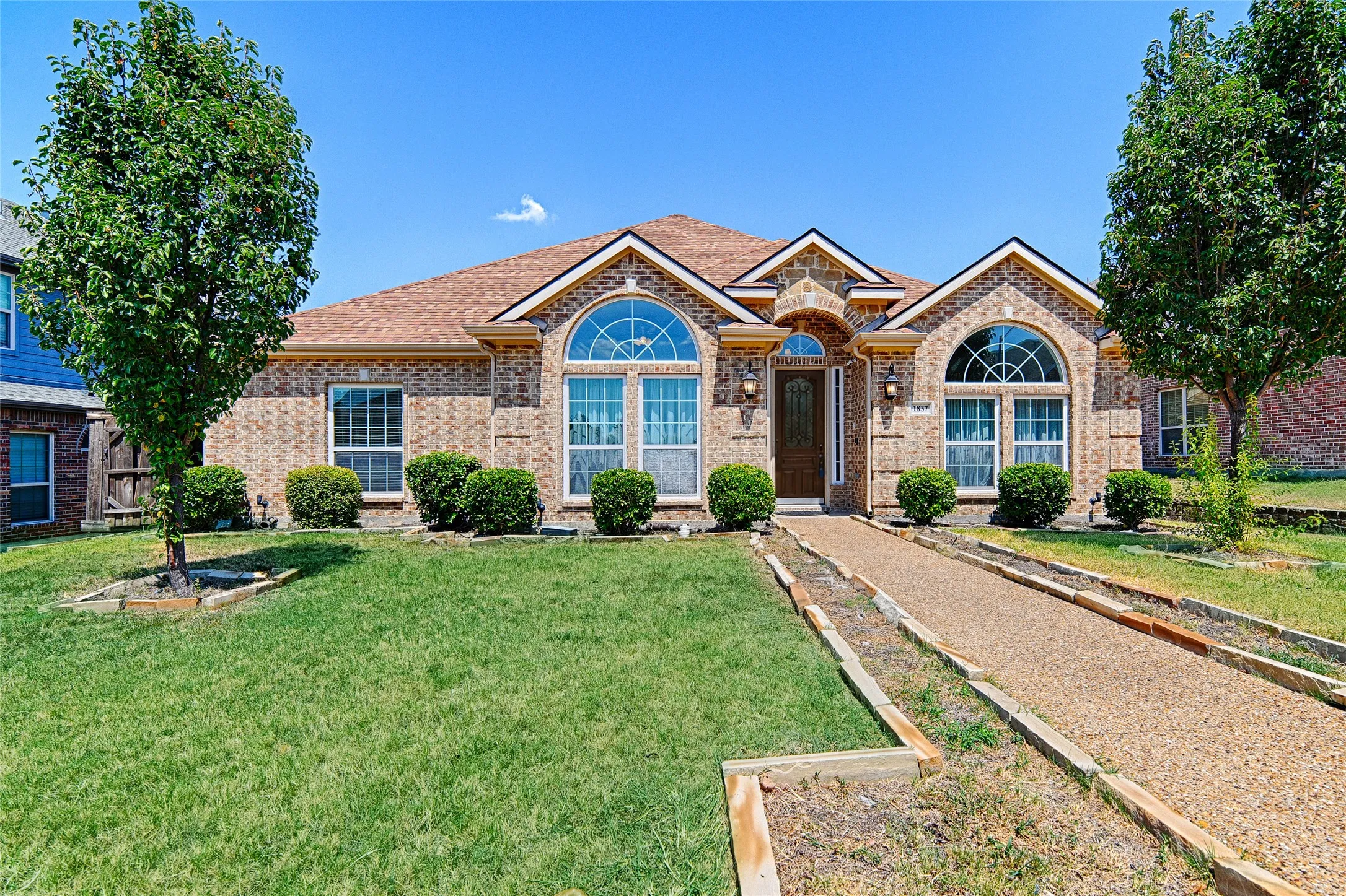 Brick exterior featuring arched windows