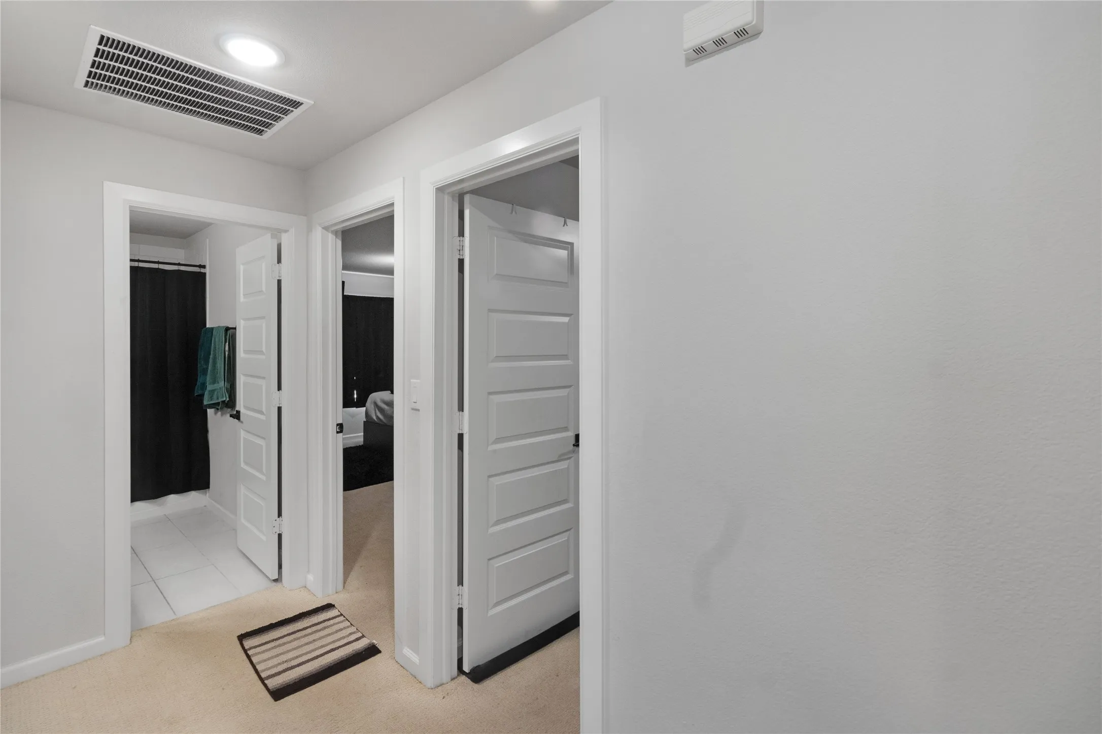 Recessed ceiling lighting, white interior doors, and a neutral wall finish