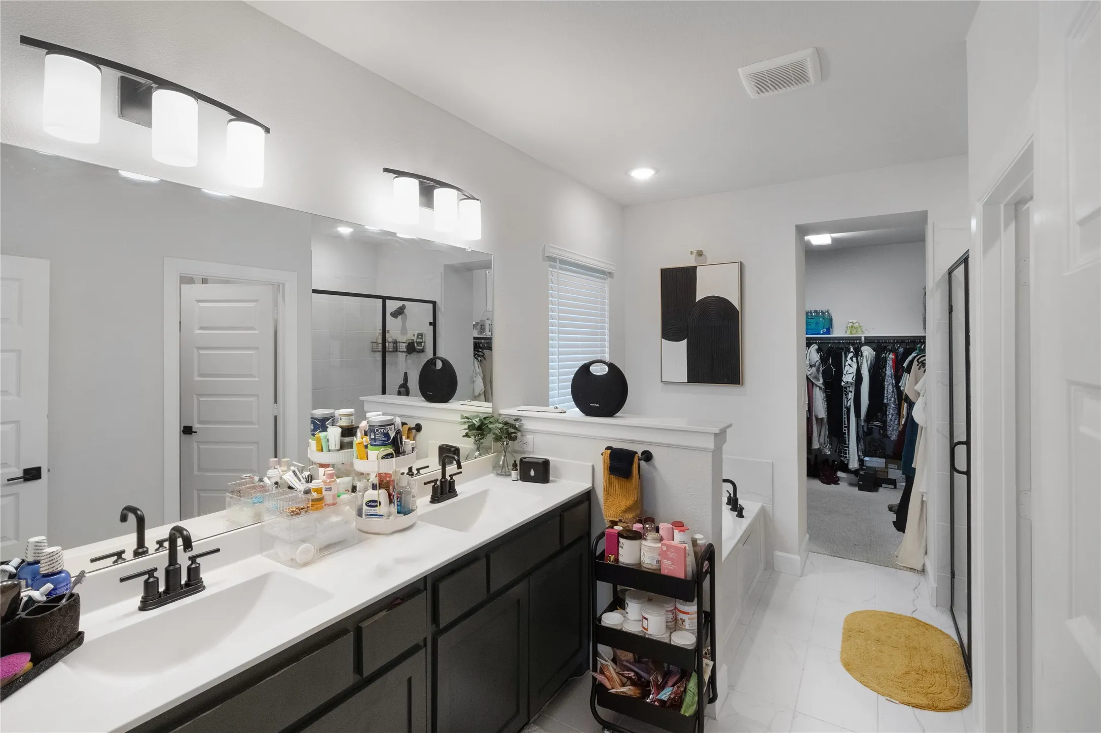 Dual vanity with integrated sinks, dark cabinetry, and matte black fixtures