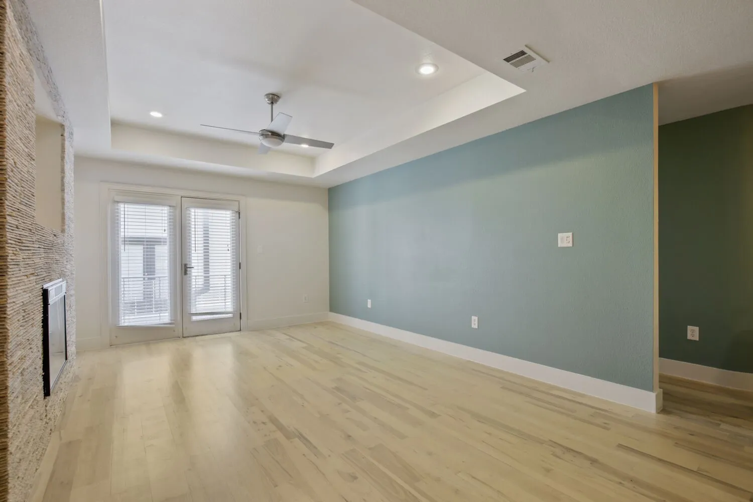 Recessed lighting, ceiling fan, tray ceiling, wood-finish flooring, and French doors with blinds