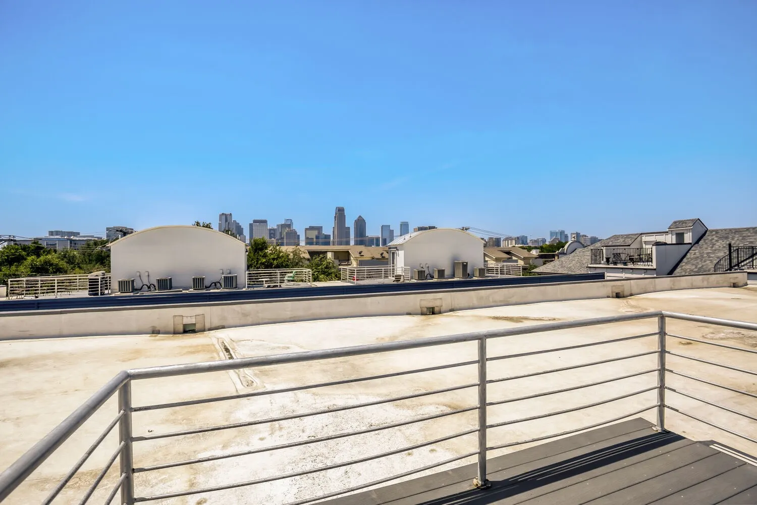 Rooftop deck featuring metal railings and composite decking