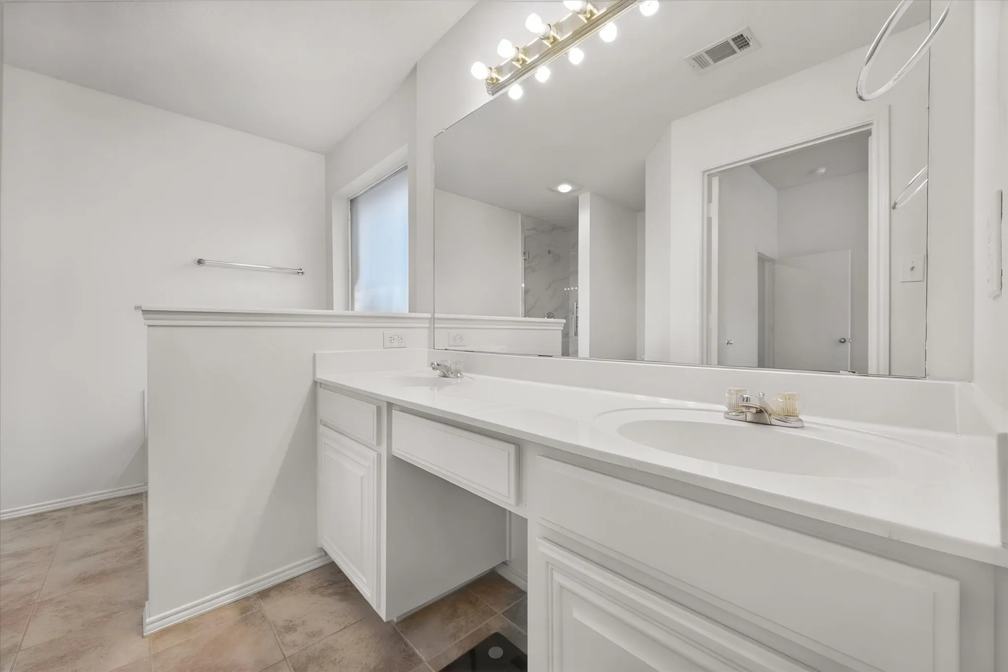 Dual vanity with integrated sinks, white cabinetry, and a dedicated vanity area