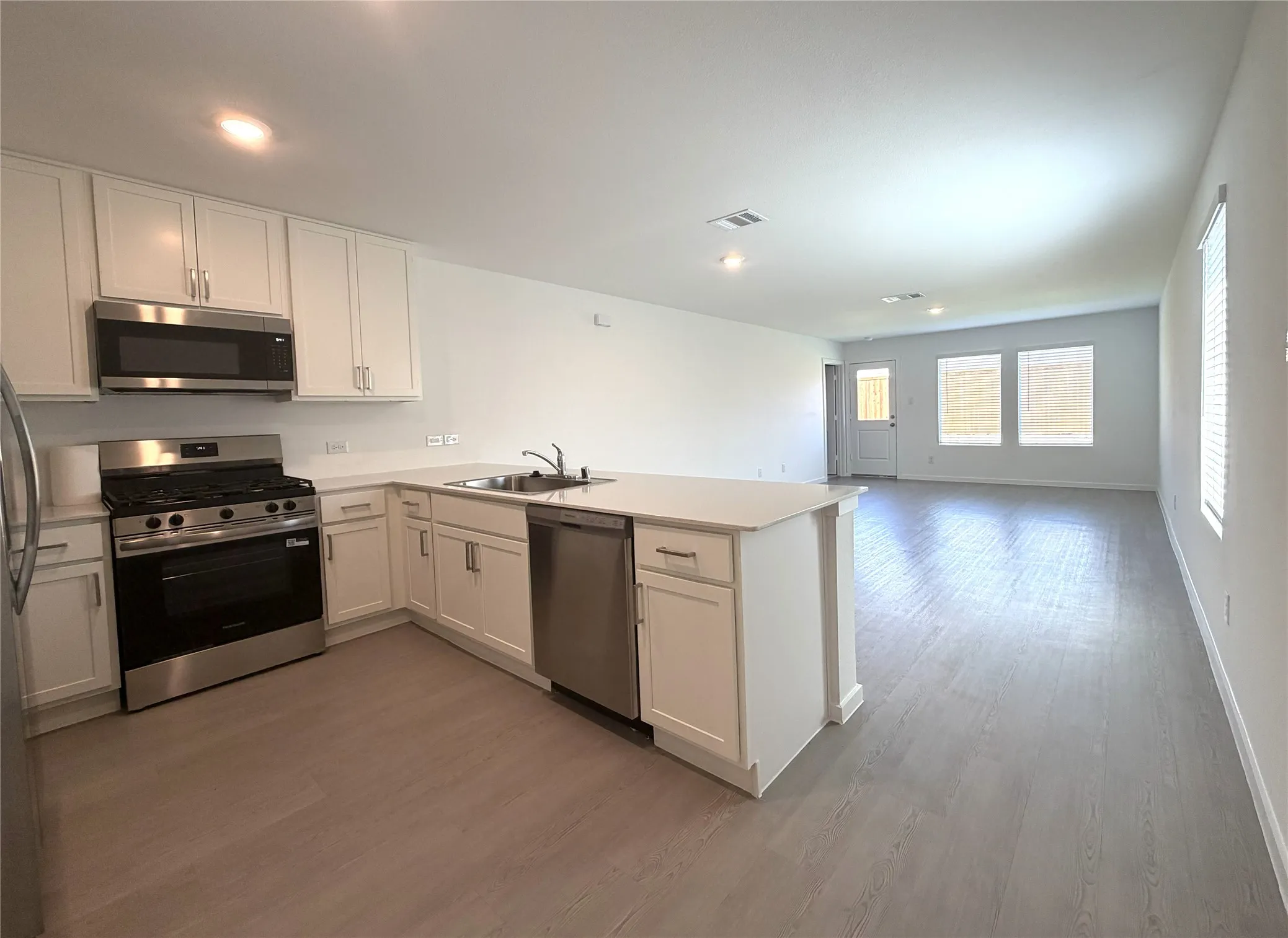 Open Floor Plan. View of Kitchen, Living Area, and Dining Area.