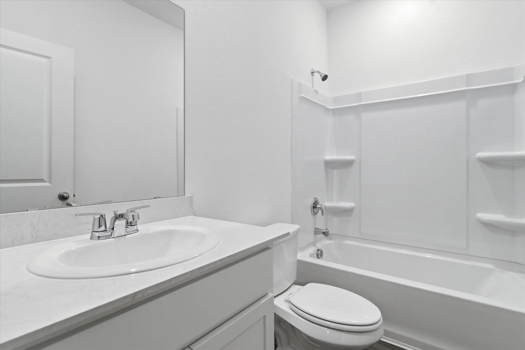 Single vanity with a light-toned countertop, integrated sink, and chrome faucet