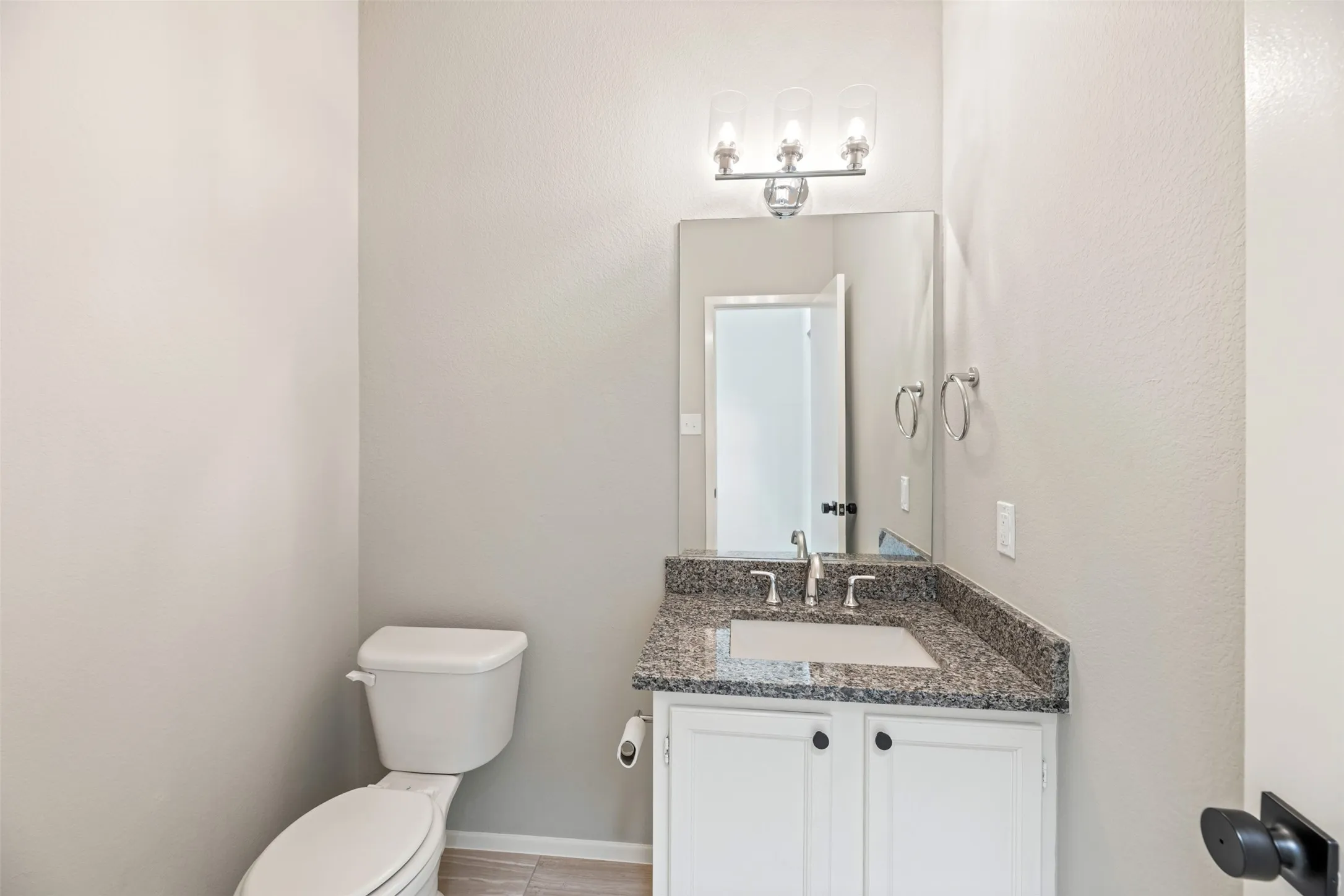 Half bathroom down stairs has new granite, faucet and light fixture