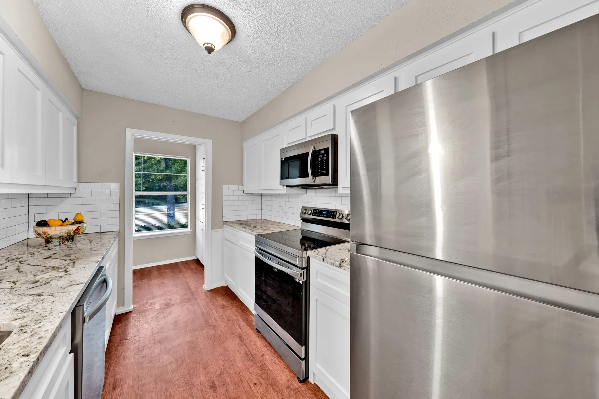 galley type kitchen , new stove, microwave, sink, dishwasher