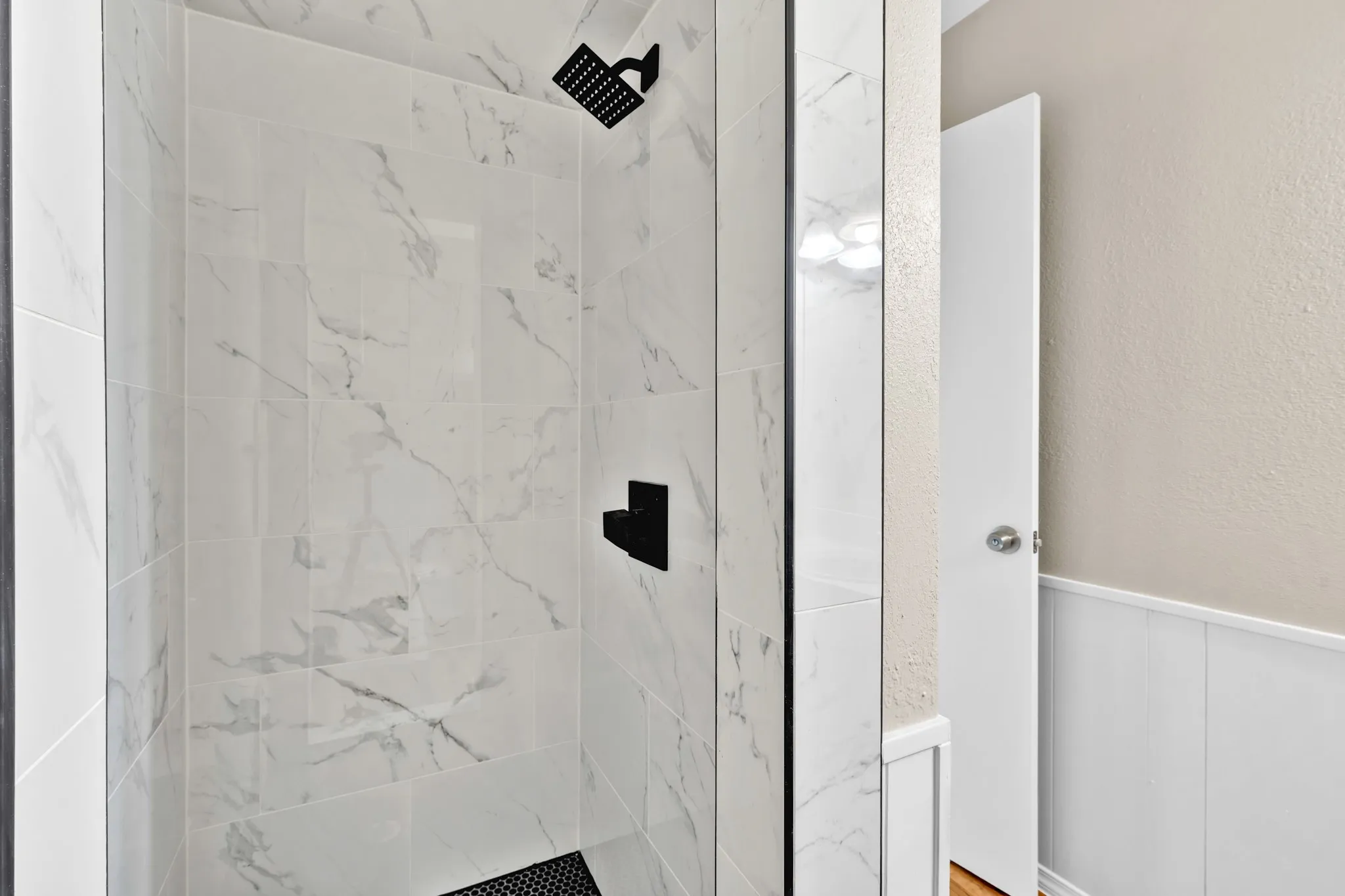 new tiled shower in primary bathroom