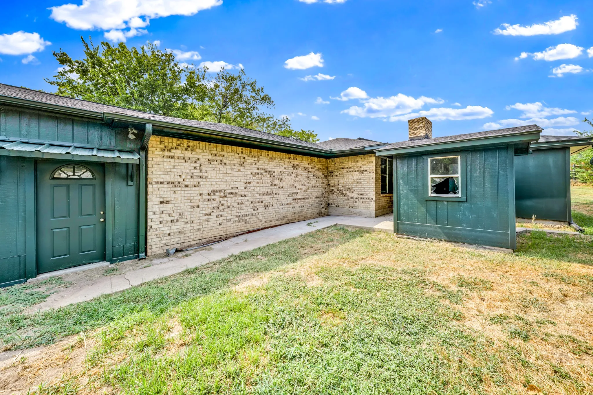 this shows door to garage from the back yard on the left with small storage on the right