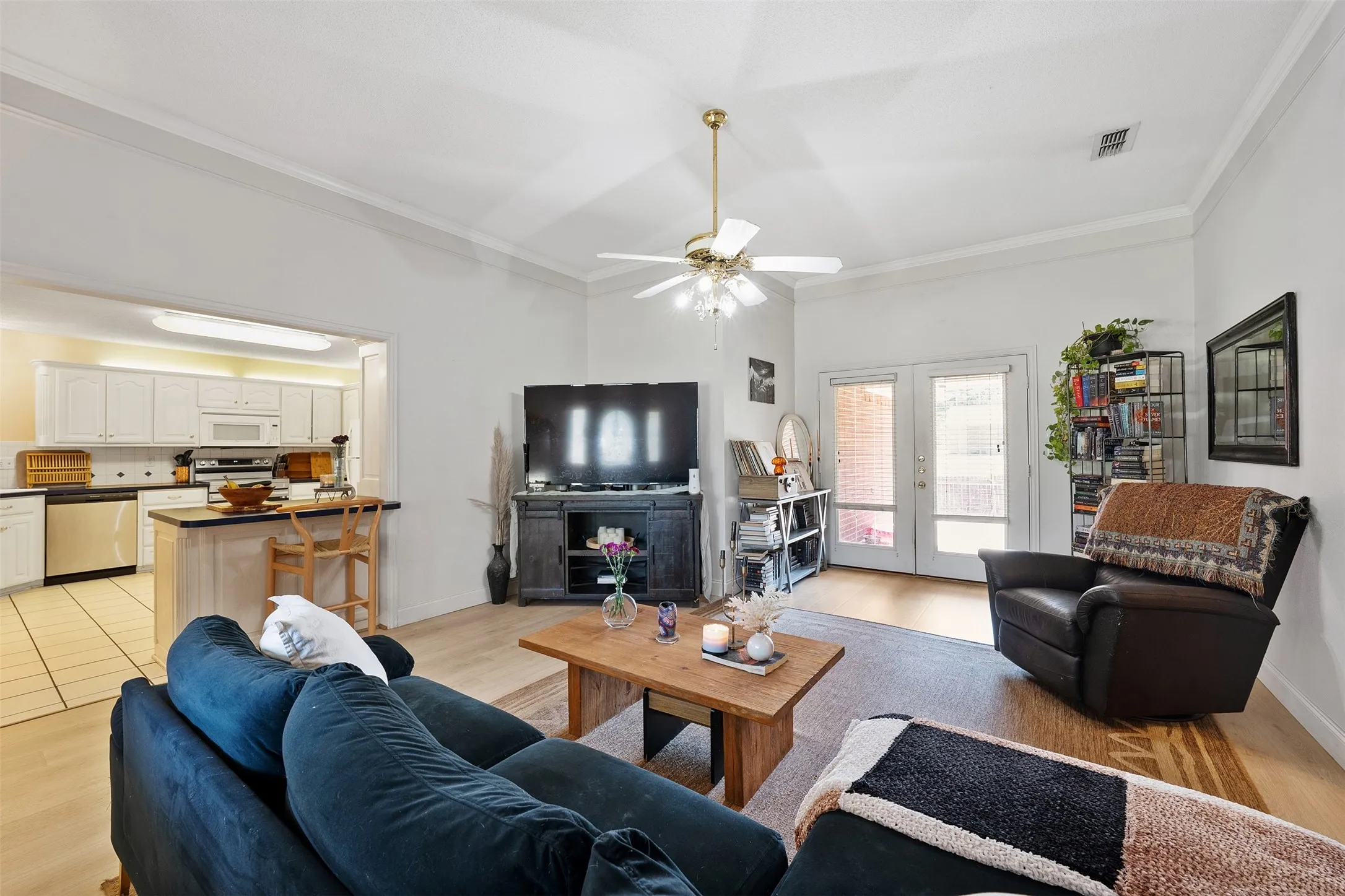 Recessed lighting, wood-finish flooring, and white crown molding