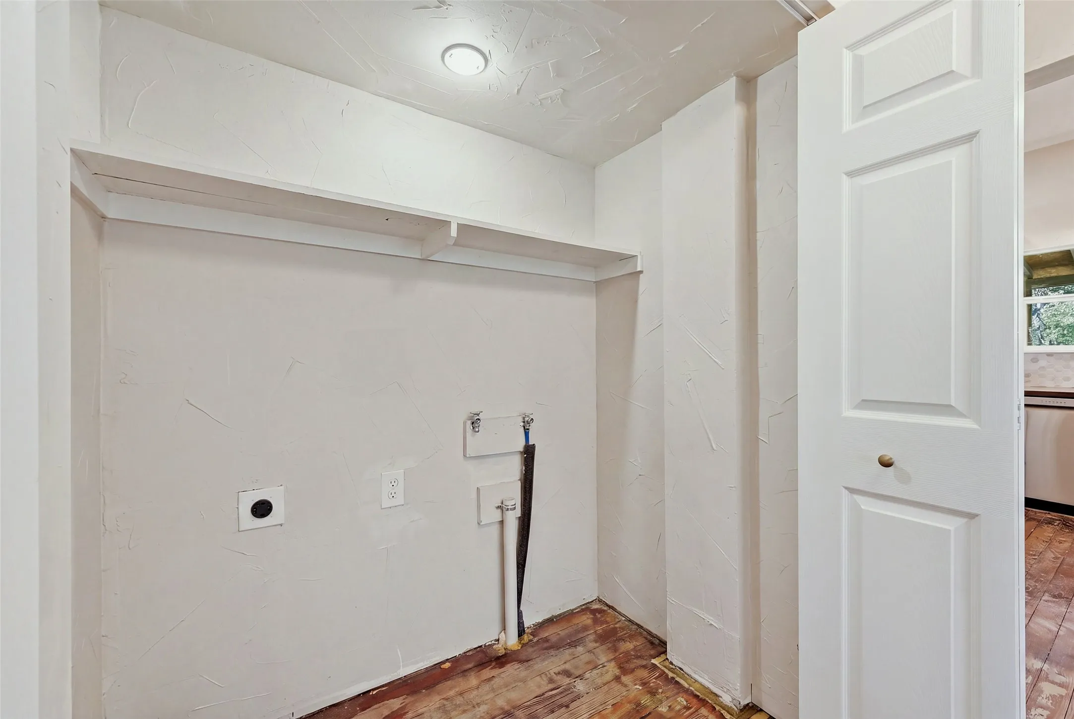 Laundry area featuring built-in shelving, panel door, and recessed lighting