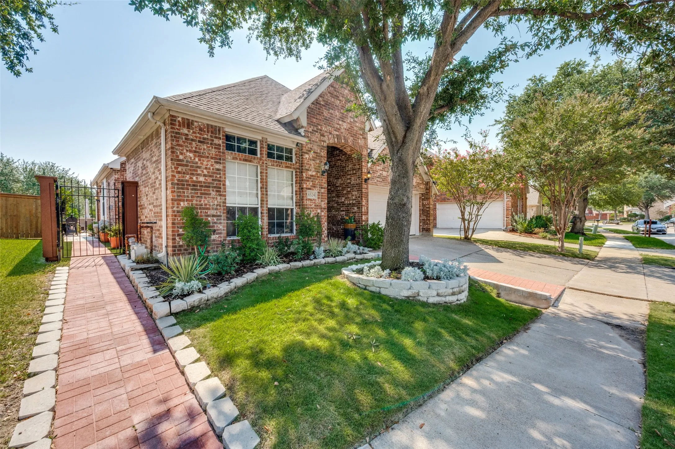 Another view of the front yard and concrete driveway