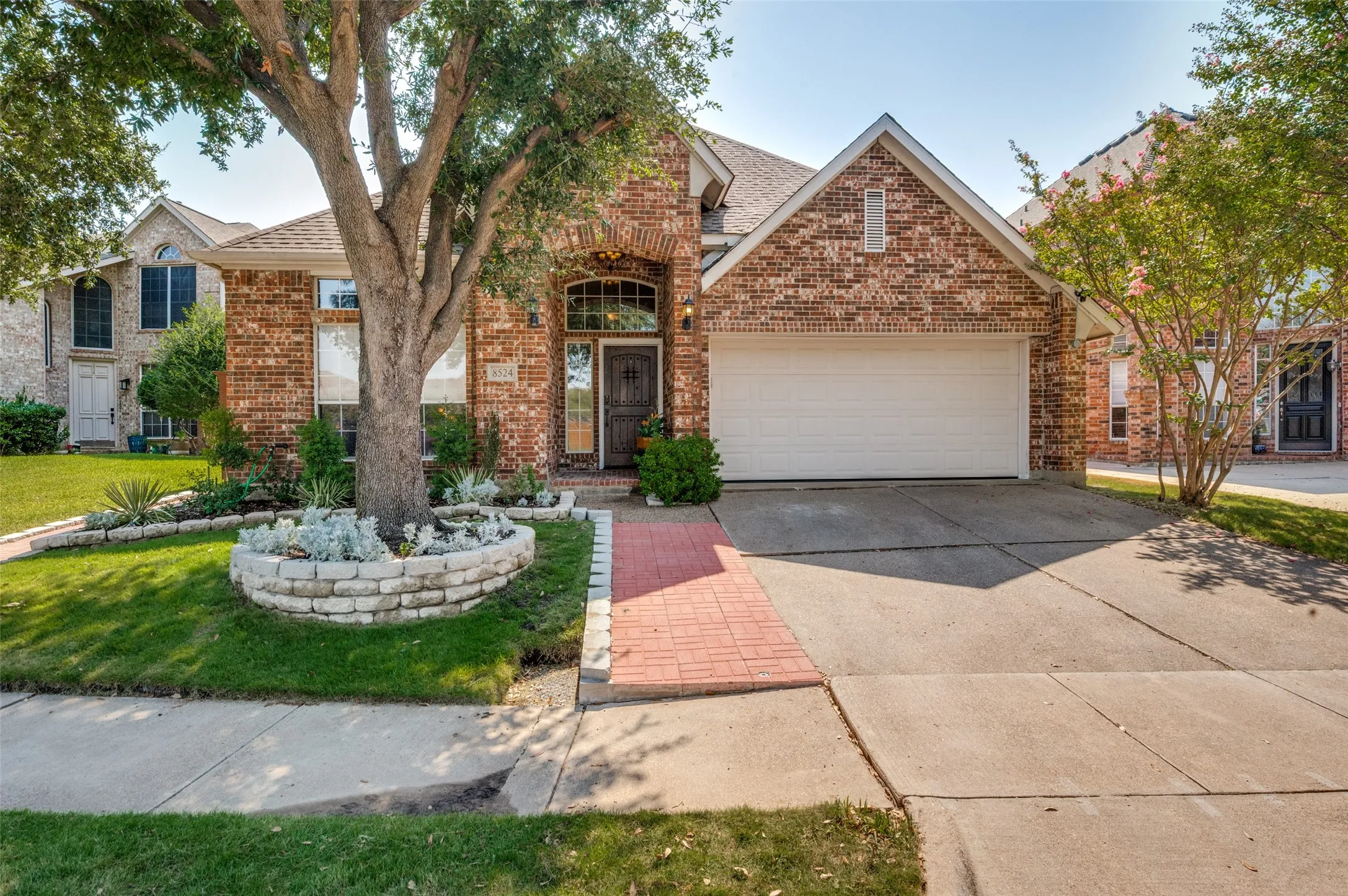 Brick exterior with stone accents and an arched entryway