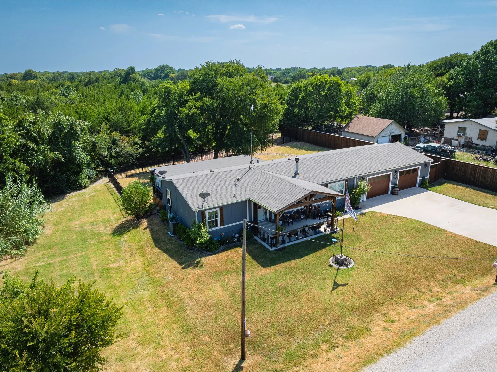 Single-story residence with a covered front porch, attached two-car garage, and a concrete driveway