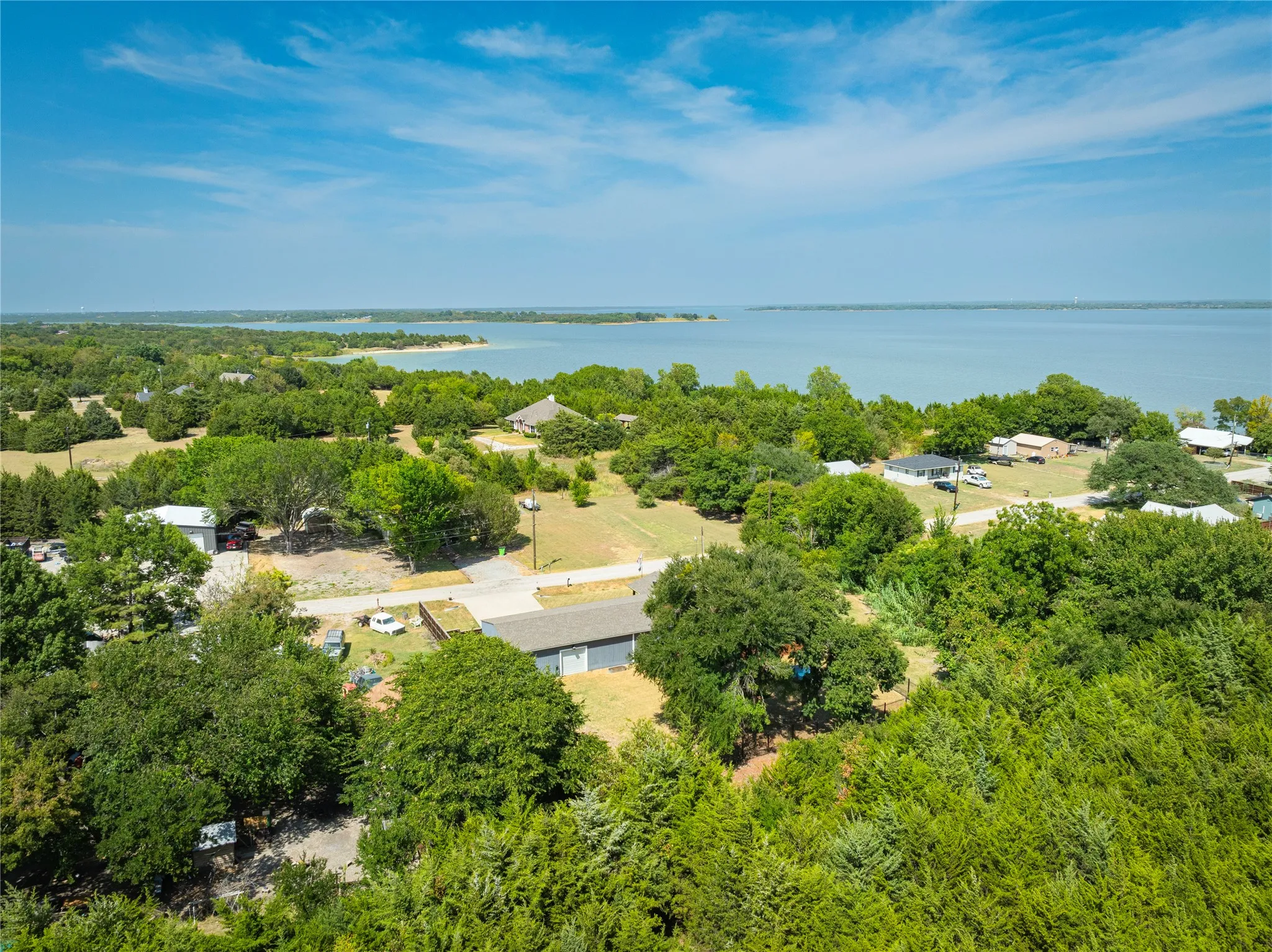 Expansive natural landscape featuring lush trees and a prominent body of water