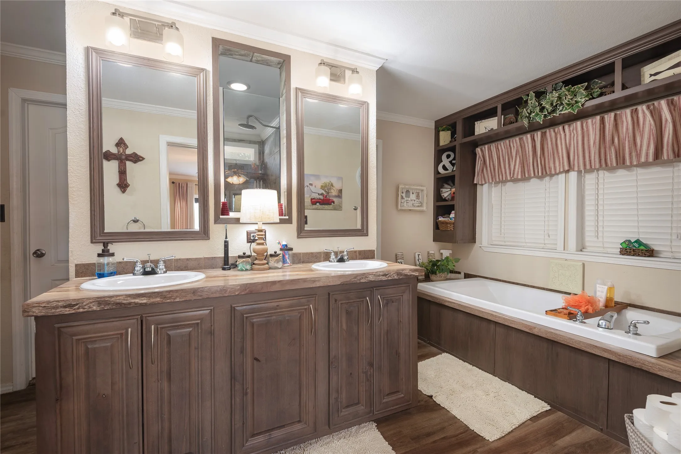 Double vanity with wood-finish cabinetry and oval sinks
