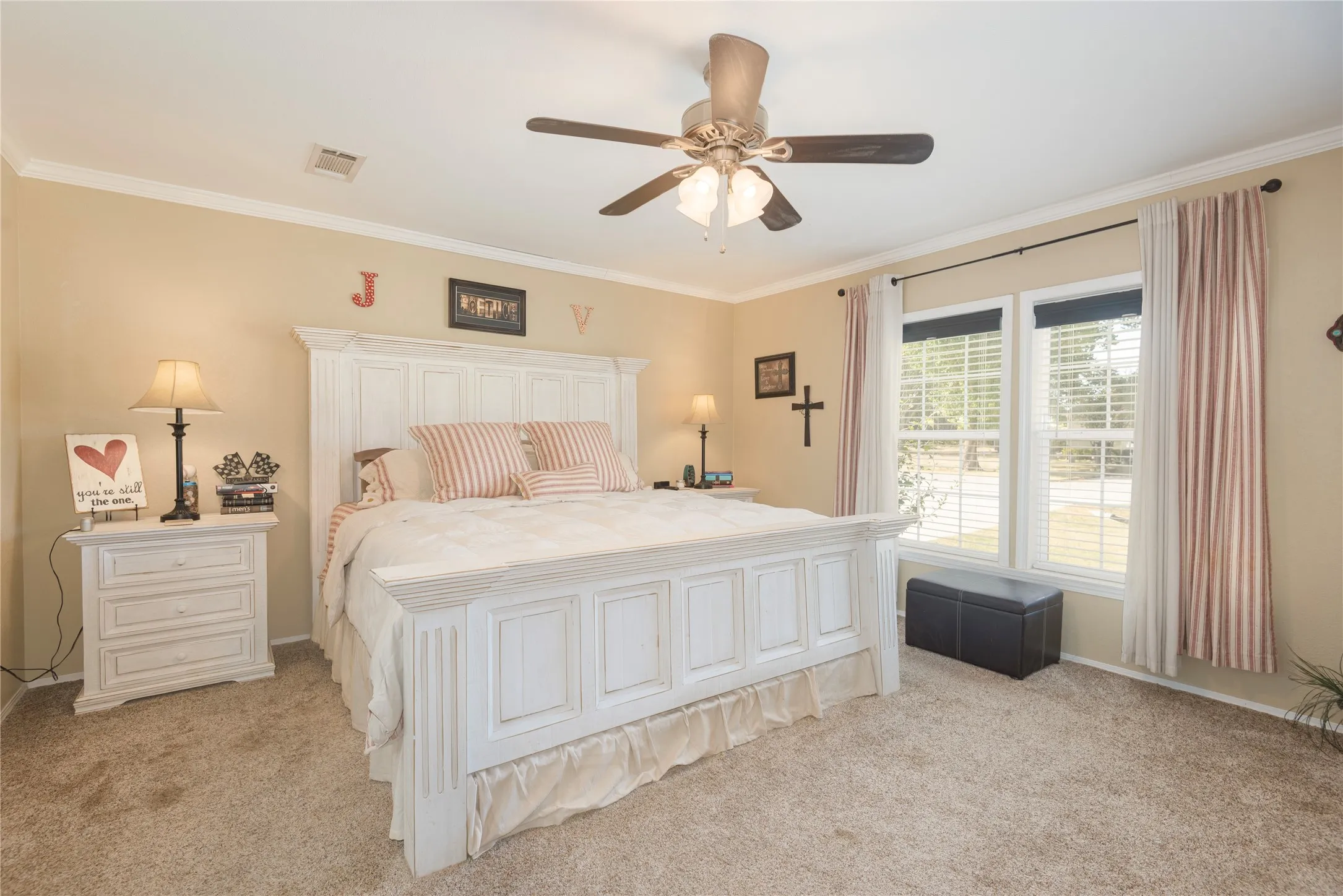Warm-toned walls featuring white crown molding and trim