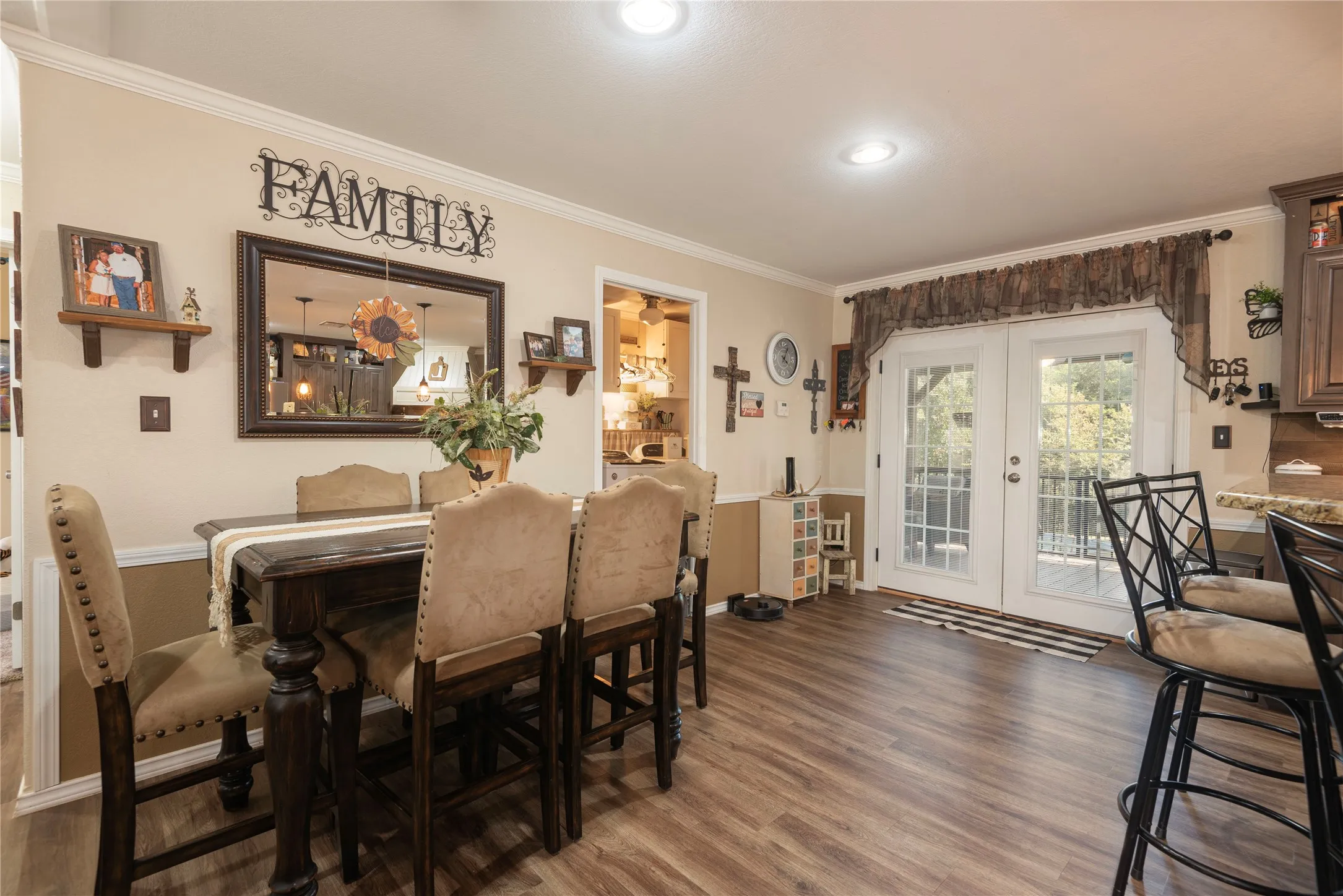Wood-finish flooring throughout, crown molding, and recessed lighting